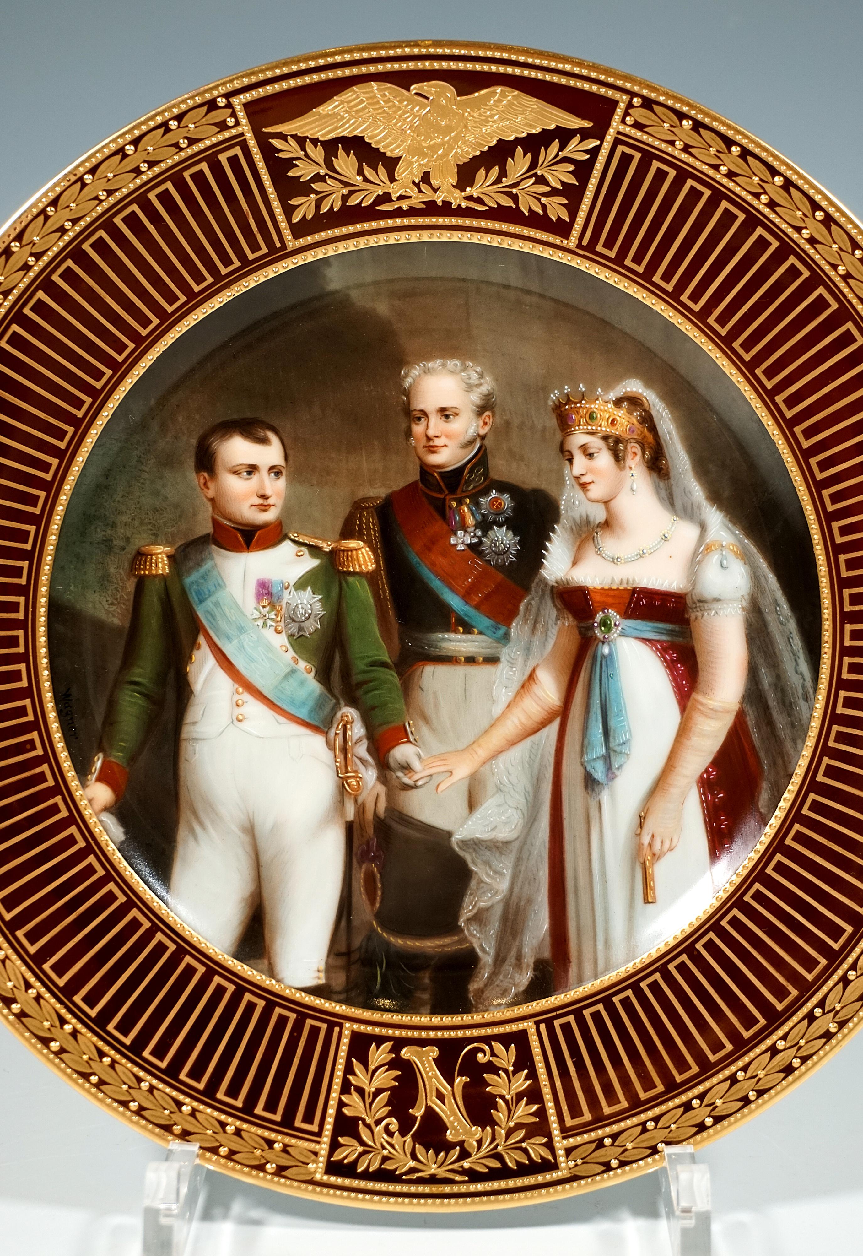 Very elaborately decorated porcelain plate: the centre is completely filled by a finely painted polychrome image, framed by a delicate pearl border painted in gold on gold: it depicts Emperor Napoleon I of France in his uniform, reaching out his