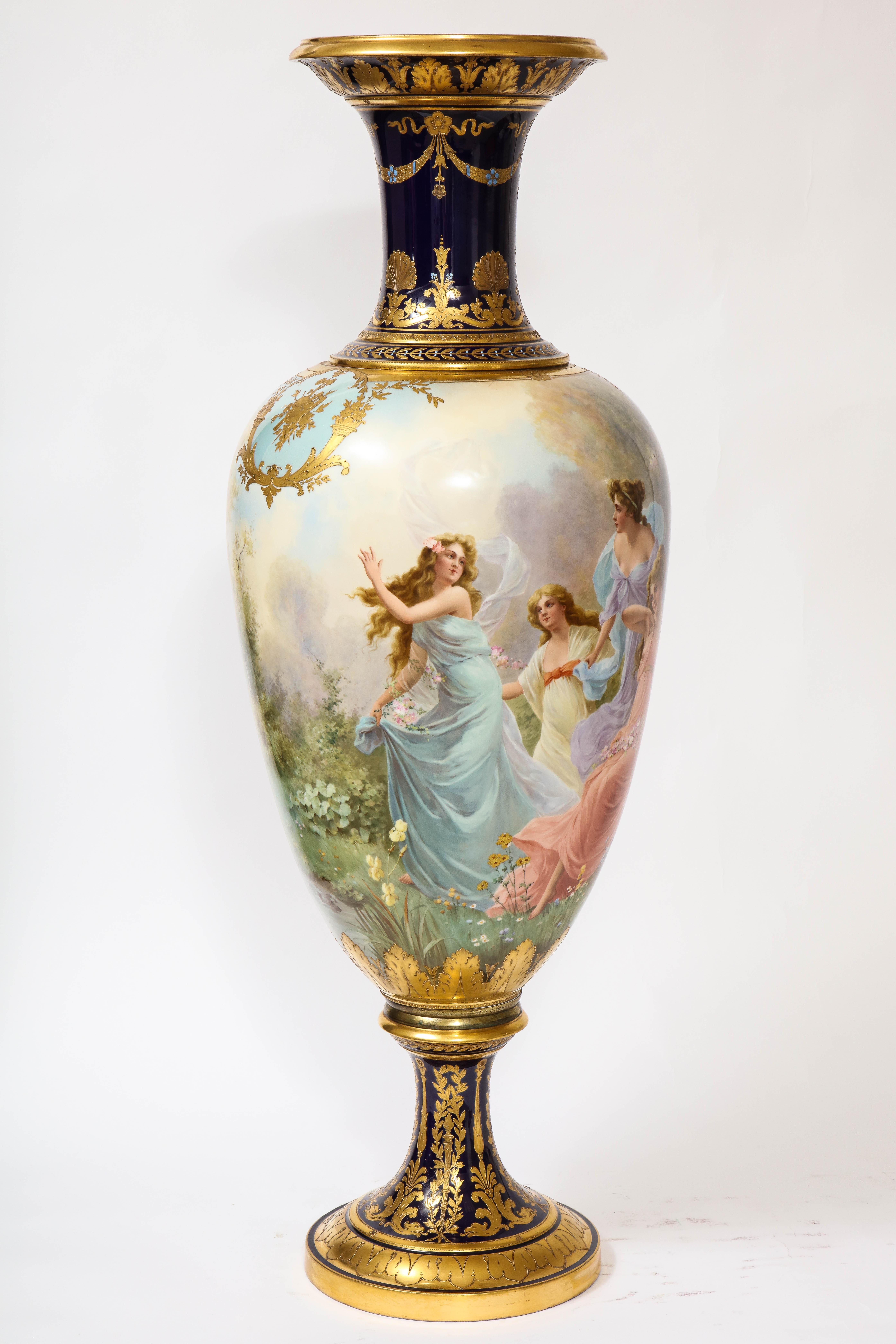 A Monumental and Exquisite Royal Vienna Porcelain cobalt blue ground turquoise jeweled vase, signed by the artist: O. Zwierzina, Lenzesfreuden. The center body is gorgeously hand painted with a continuum of four maidens, classically-dressed in a