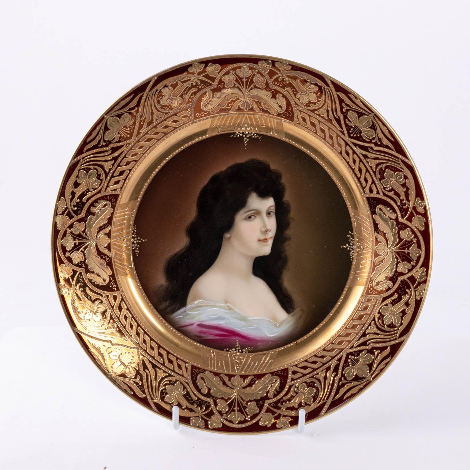 Royal Vienna portrait plate in porcelain, circa 1890-1910. The piece features hand painted gold floral work on the boarder and a portrait of a women in the center. Please note of wear consistent with age including minor paint loss. Made in Austria.