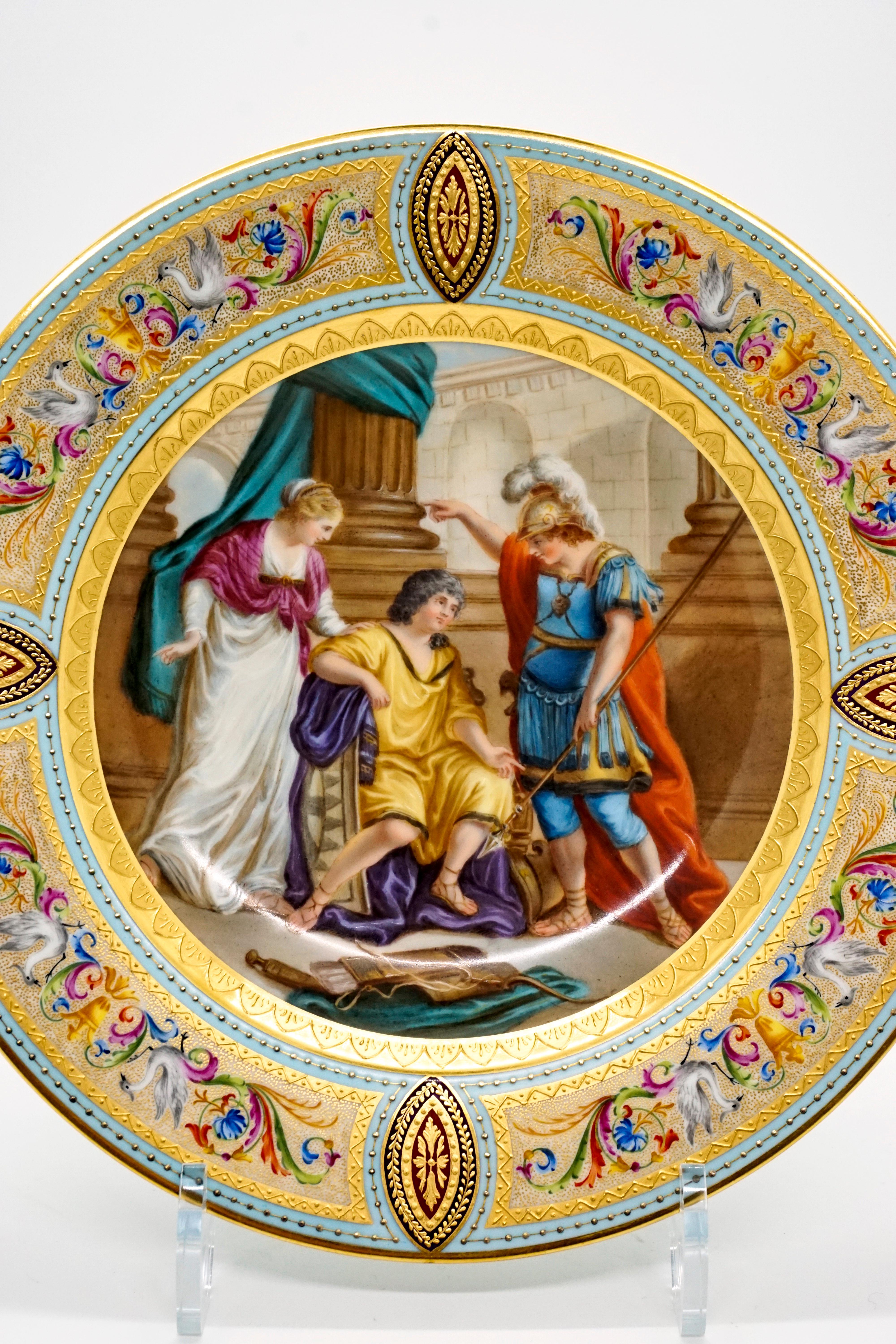 Elaborately painted porcelain picture plate: gold rim on the outside, light blue flag with four large reserves with pastose decorated gold frame and with a white, gold-dotted background, filled with polychrome feather tendrils and two herons painted