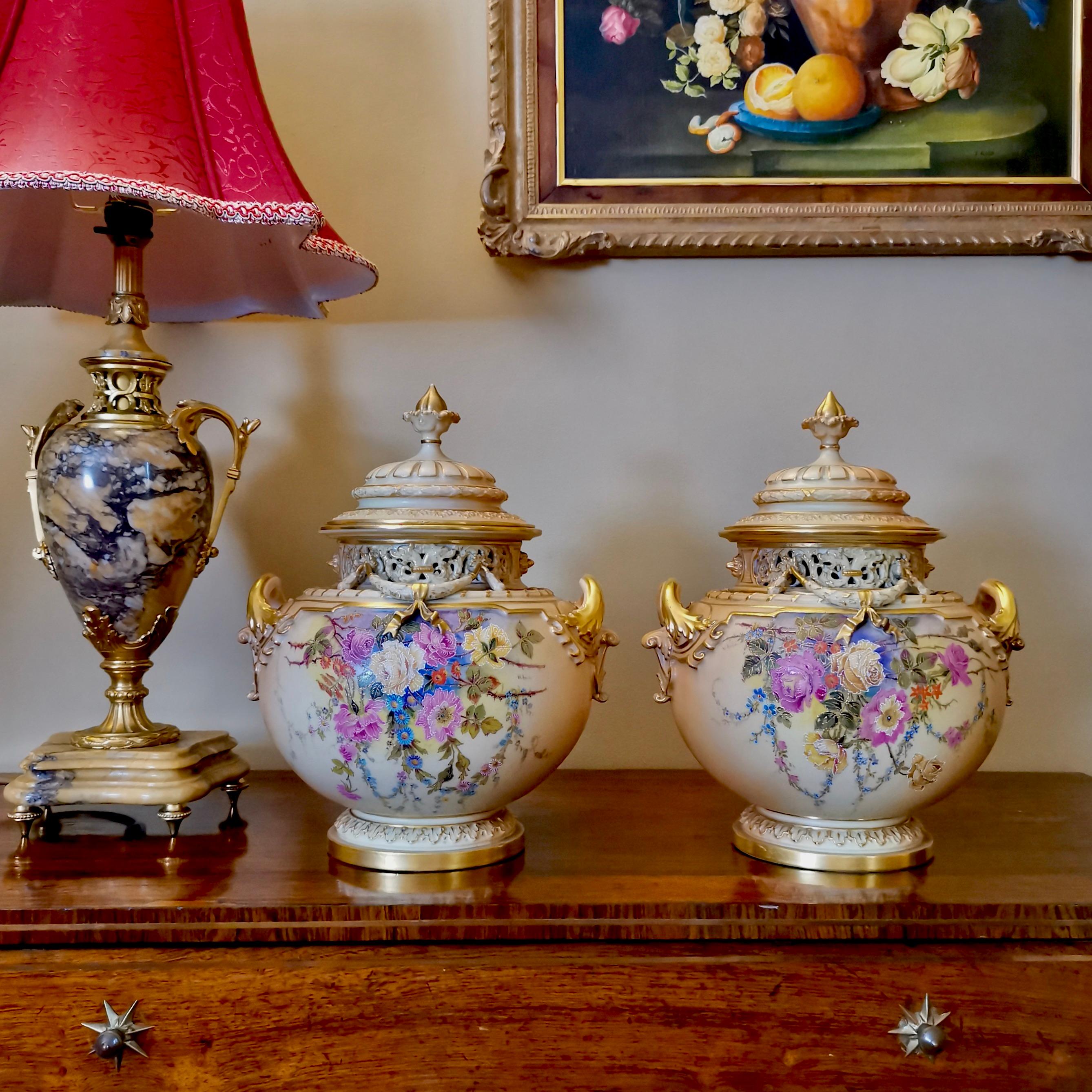 This is a very fine pair of lidded potpourri vases made by Royal Worcester in 1909. The potpourris are in the 