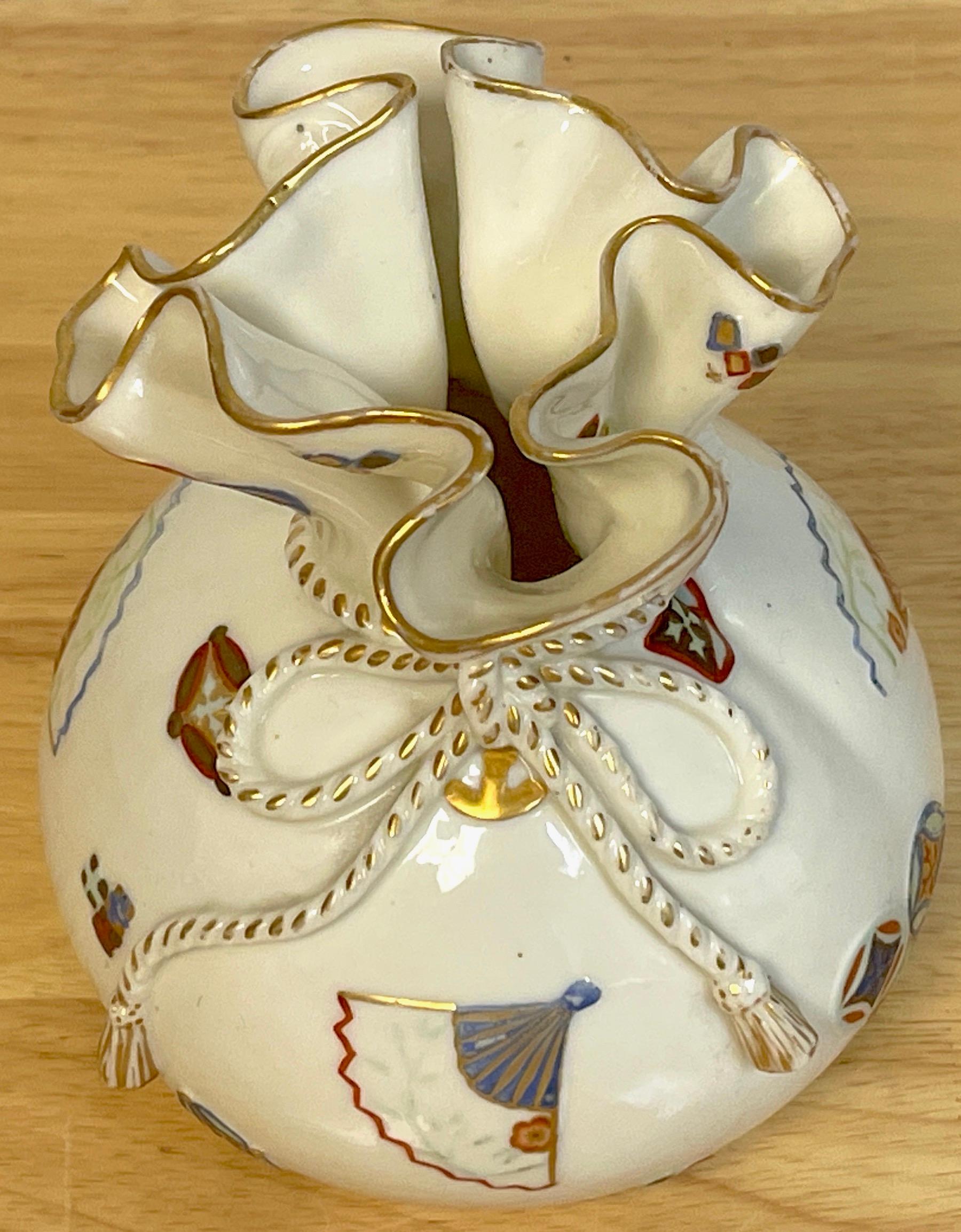 Royal Worcester Aesthetic / Japonisme handkerchief vase, 1876
A fine example of the English Aesthetic Movement, realistically modeled of sparsely decorated and molded with precious objects and symbols. Ruffled 4-Inch diameter top with intertwined