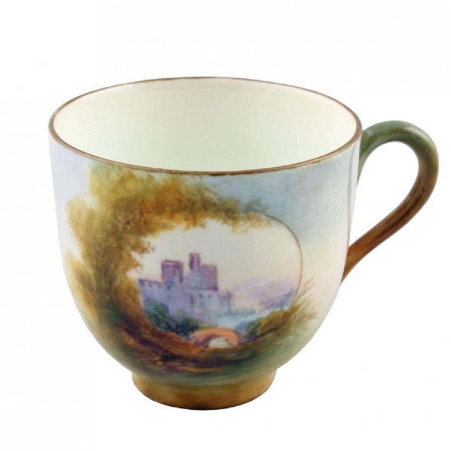 An early 20th century small Royal Worcester china cup and saucer.

The cup is hand painted with a central scene of a castle, trees and is signed 'Rushton'.

The saucer is painted with a different scene of a castle and is also signed