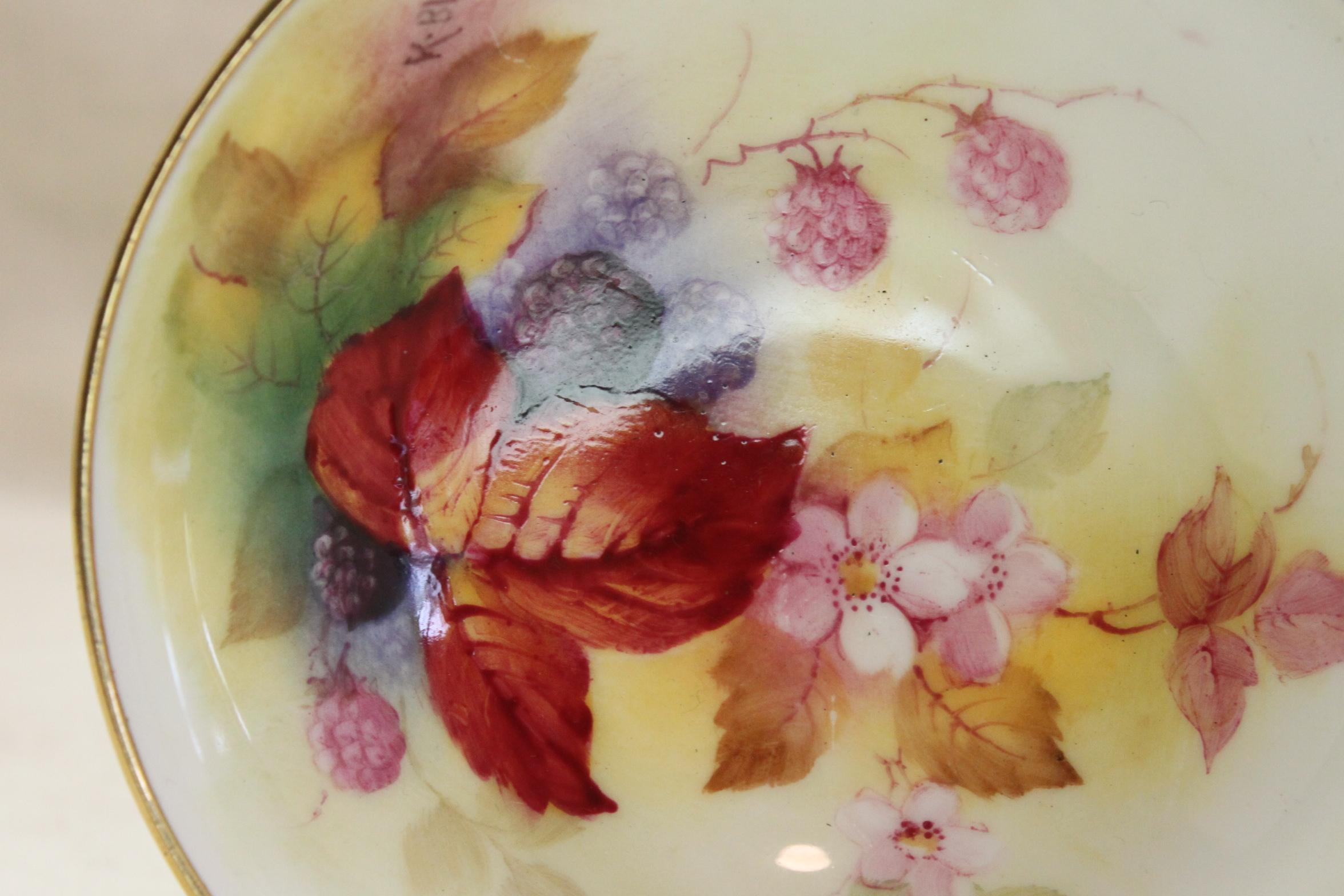 This small footed dish is decorated with Kitty Blake's trademark hand painted blackberries, flowers and foliage, done in autumnal tones, and enhanced with gilding to the rim and foot. Kitty Blake worked at the Royal Worcester factory for 48 years,