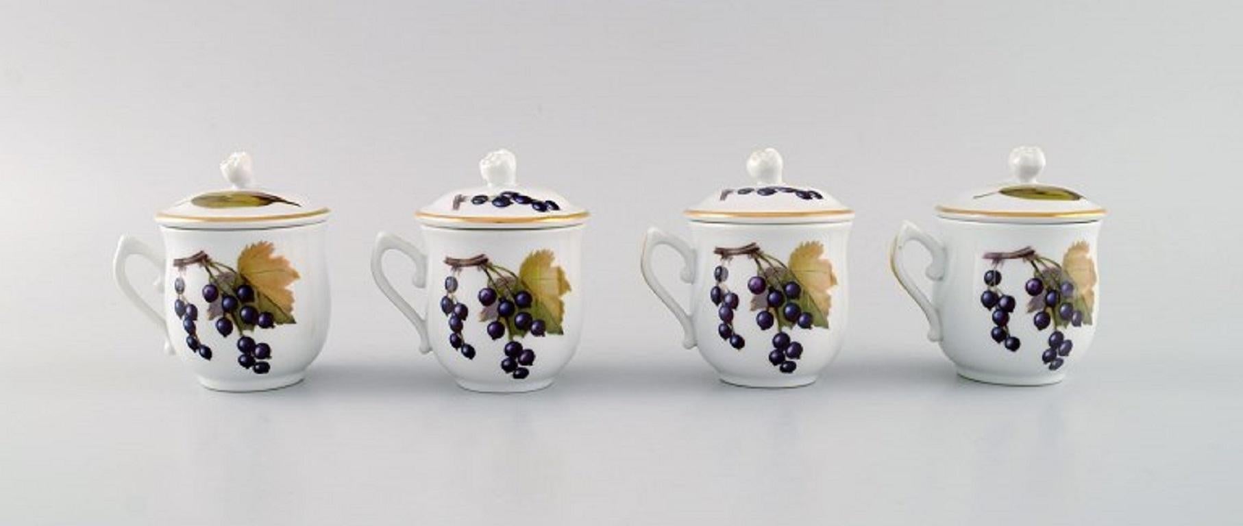 Royal Worcester, England. Four Evesham porcelain cream cups decorated with fruits and gold edge. 
1960s.
Measures: 8.5 x 7.7 cm.
In excellent condition.
Stamped.