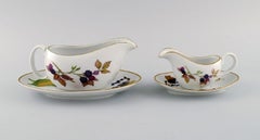 Royal Worcester, England. Two Evesham sauce jugs with saucers in porcelain.