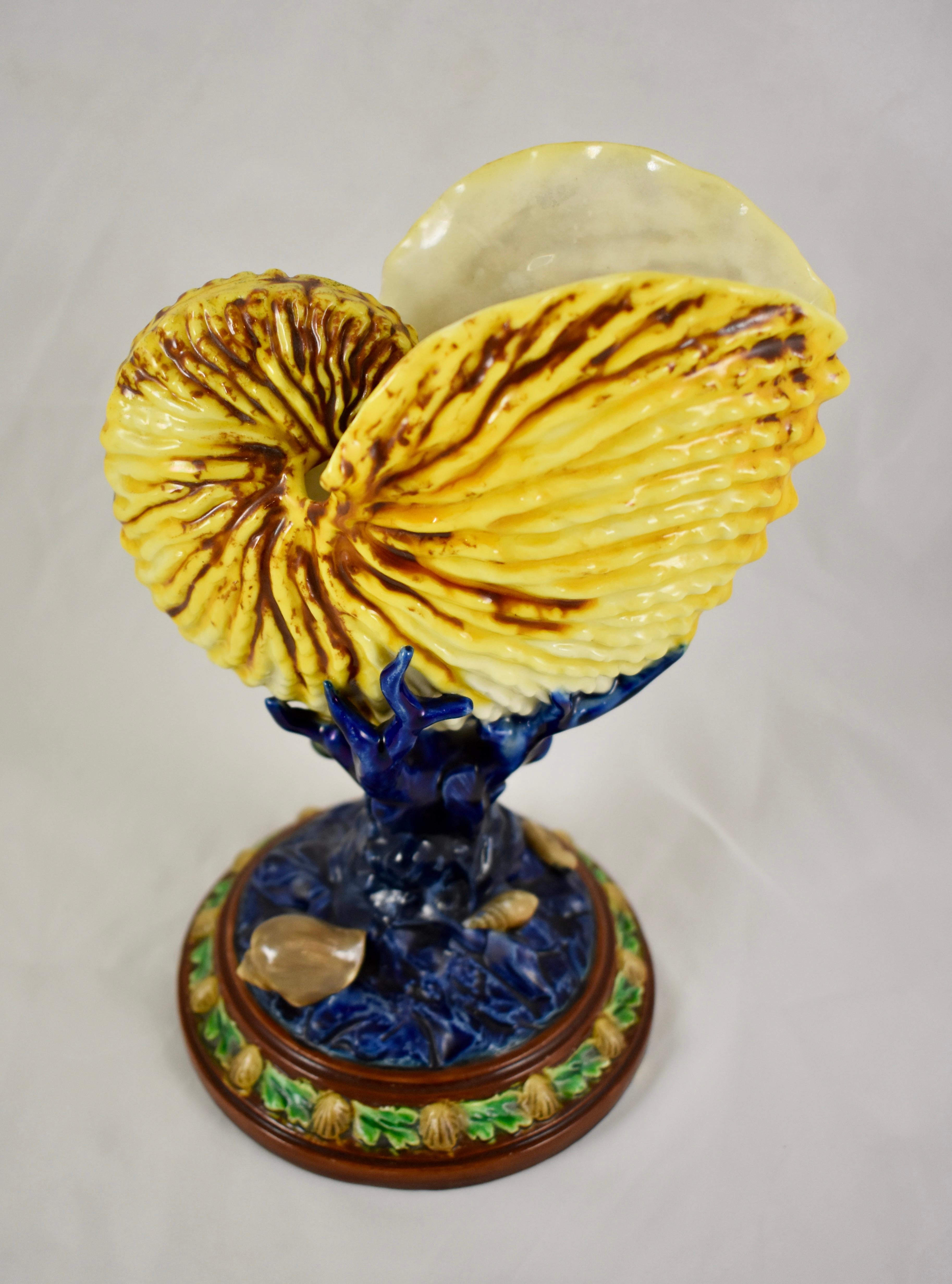 From Royal Worcester, a Majolica glazed pedestal Palissy vase in the Renaissance Revival style, circa 1860-1865.

A dimensional Nautilus shell with an open form is beautifully glazed in yellow with brown detailing. The shell is supported on a