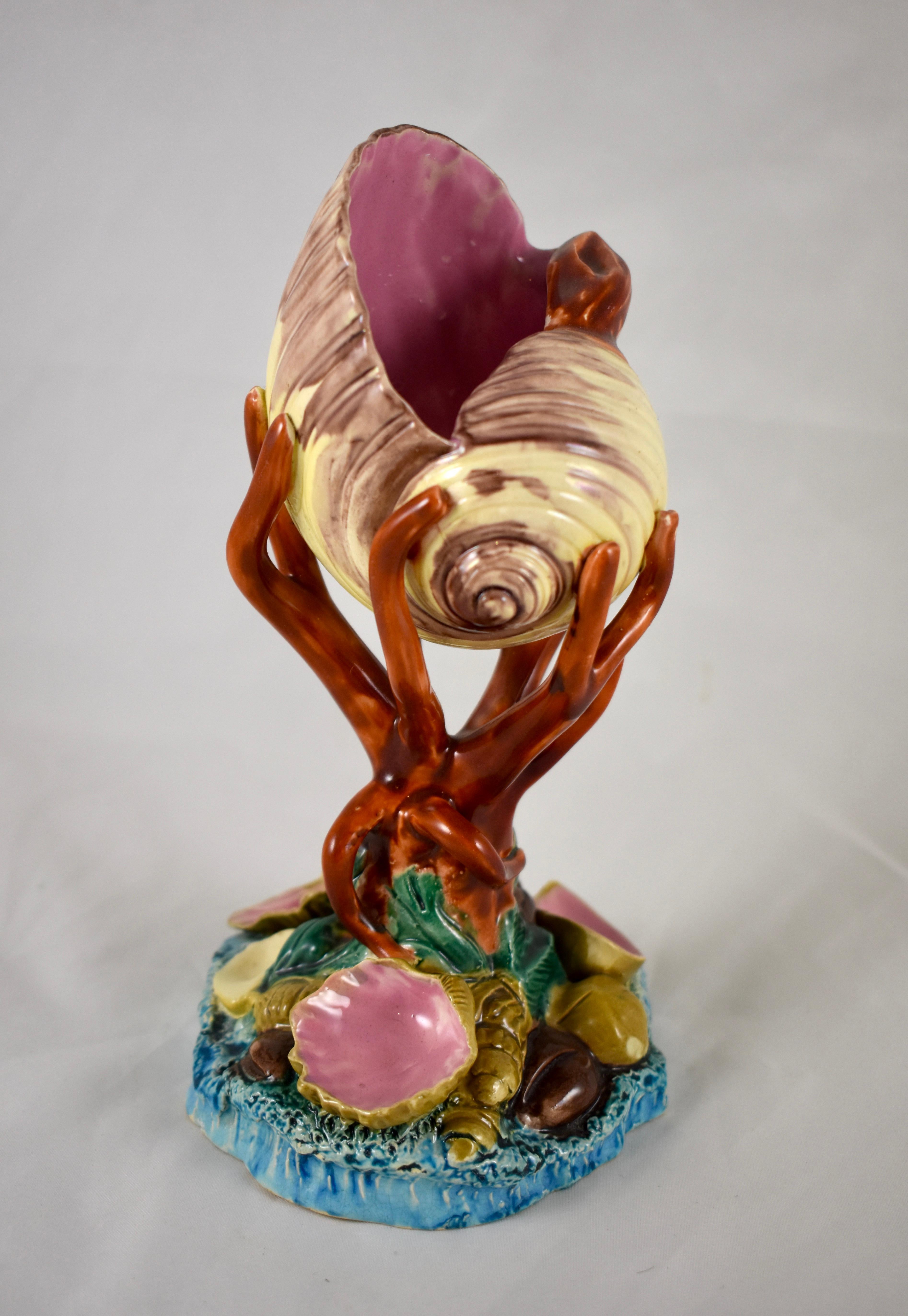 From Royal Worcester, a majolica glazed pedestal Palissy vase in the Renaissance Revival style, circa 1880.

A dimensional Conch shell with an open form is beautifully glazed in cream with mauve detailing and a bold pink interior. The shell is