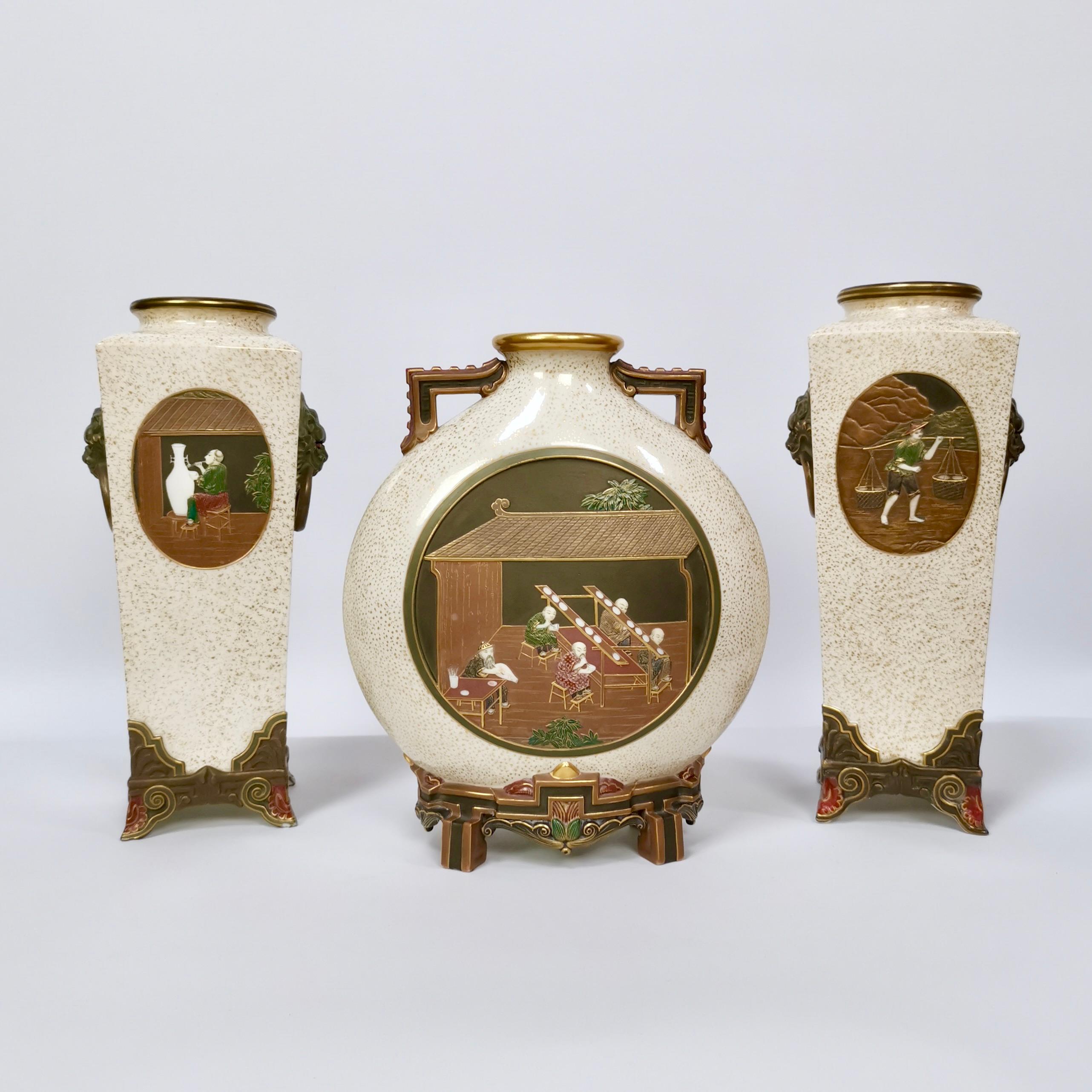 This is a superb and extremely rare garniture of three vases made by Royal Worcester in the years 1872 and 1873. The garniture consists of two square tall vases and one moon flask in the Aesthetic Movement style inspired by the Japanese Satsuma