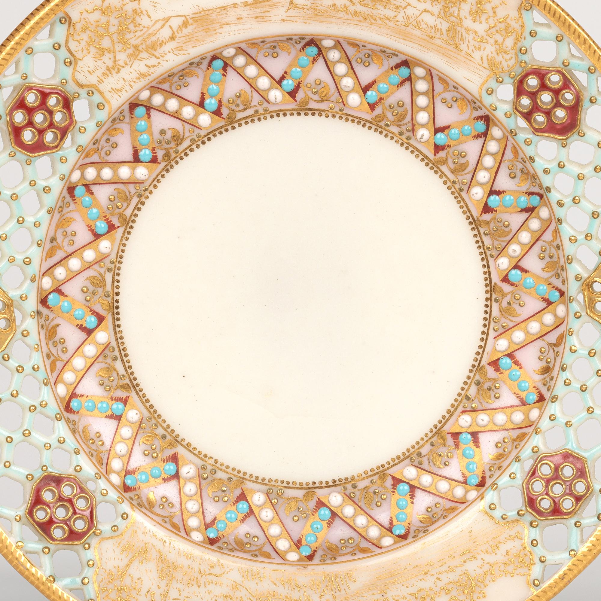 A stunning and rare antique Royal Worcester reticulated cup and saucer decorated with beadwork and painted designs by renowned and sought after potter George Owen (British, 1845-1912) and dated 1881. 

George Owen refined and produced reticulated