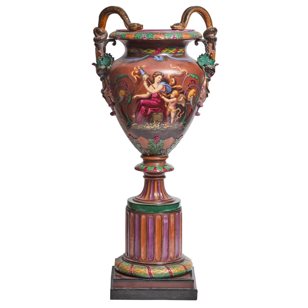 This antique majolica Exhibition vase or urn was undoubtedly made by the Royal Worcester factory in the Baroque Revival style, around 1864. The piece is stamped with the Royal Worcester crown mark thrice at the base, and it is consistent with the