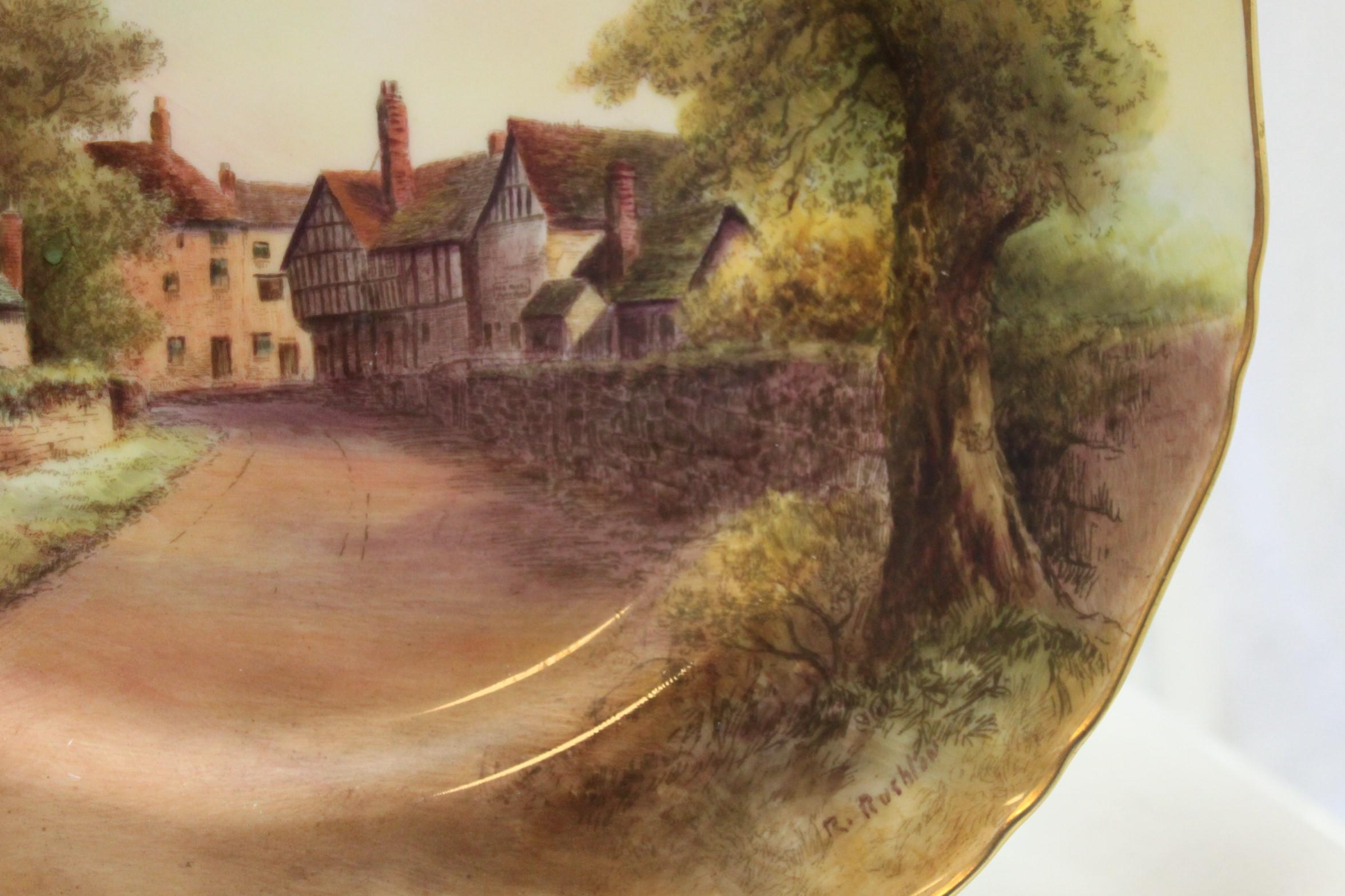 This Royal Worcester porcelain plate was hand painted by Raymond Rushton (1886-1956), and features a very detailed scene of a rural lane and time honoured buildings in Tewksbury in Gloucestershire, England. Rushton was a very fine landscape painter