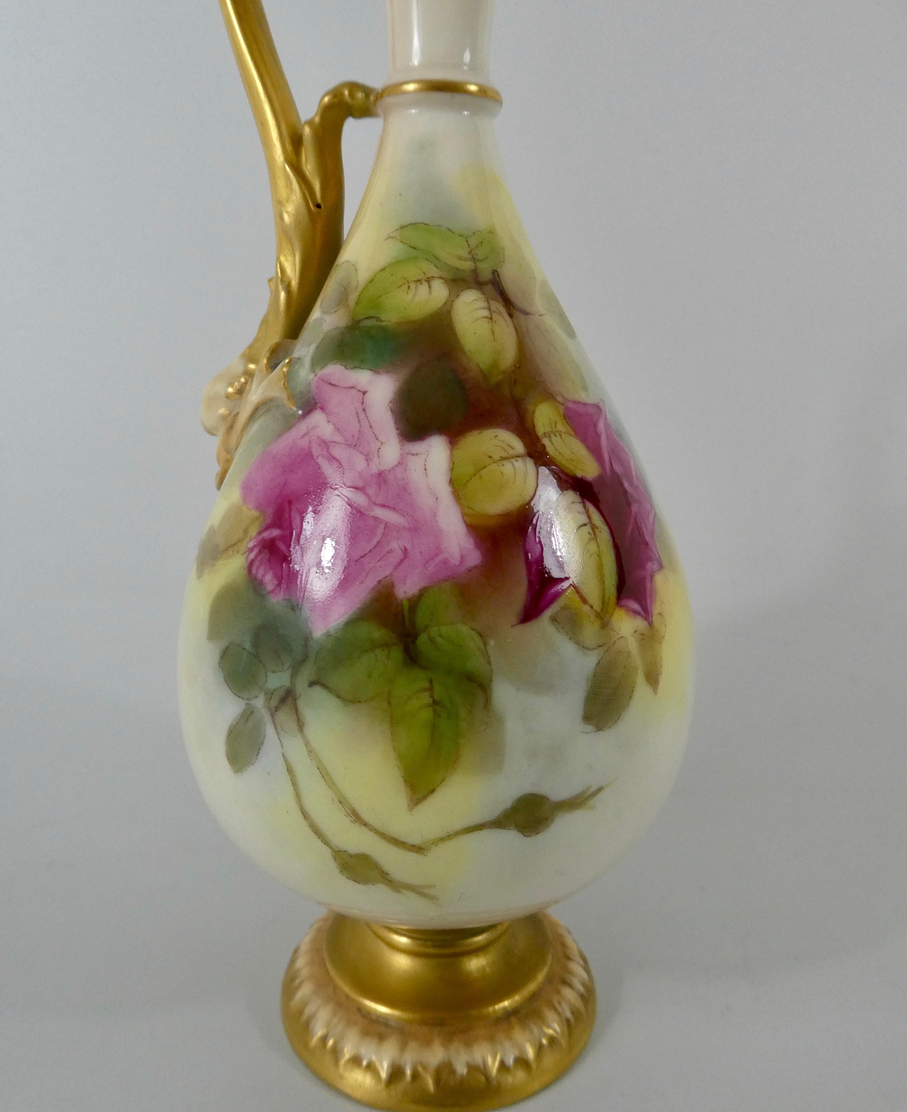 Royal Worcester porcelain ewer, dated 1919. The elegantly shaped ewer, well painted to either side with roses. Having an elaborate scroll handle, terminating in a moulded stylised dolphin head, attached to the body, and gilded.
Set upon a gilded