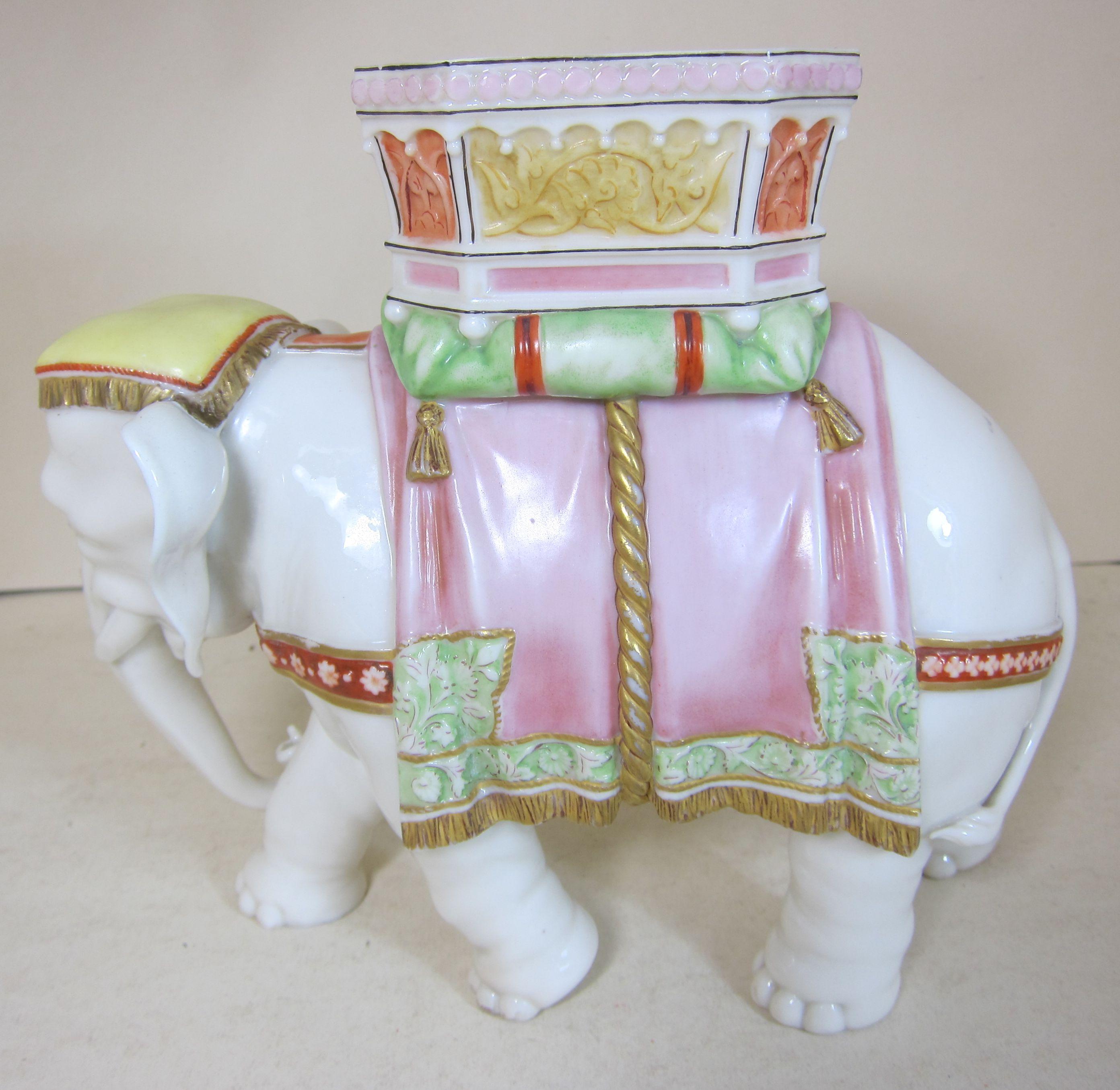 A Royal Worcester porcelain figure of an elephant in full colored ceremonial dress modelled by James Bradley.