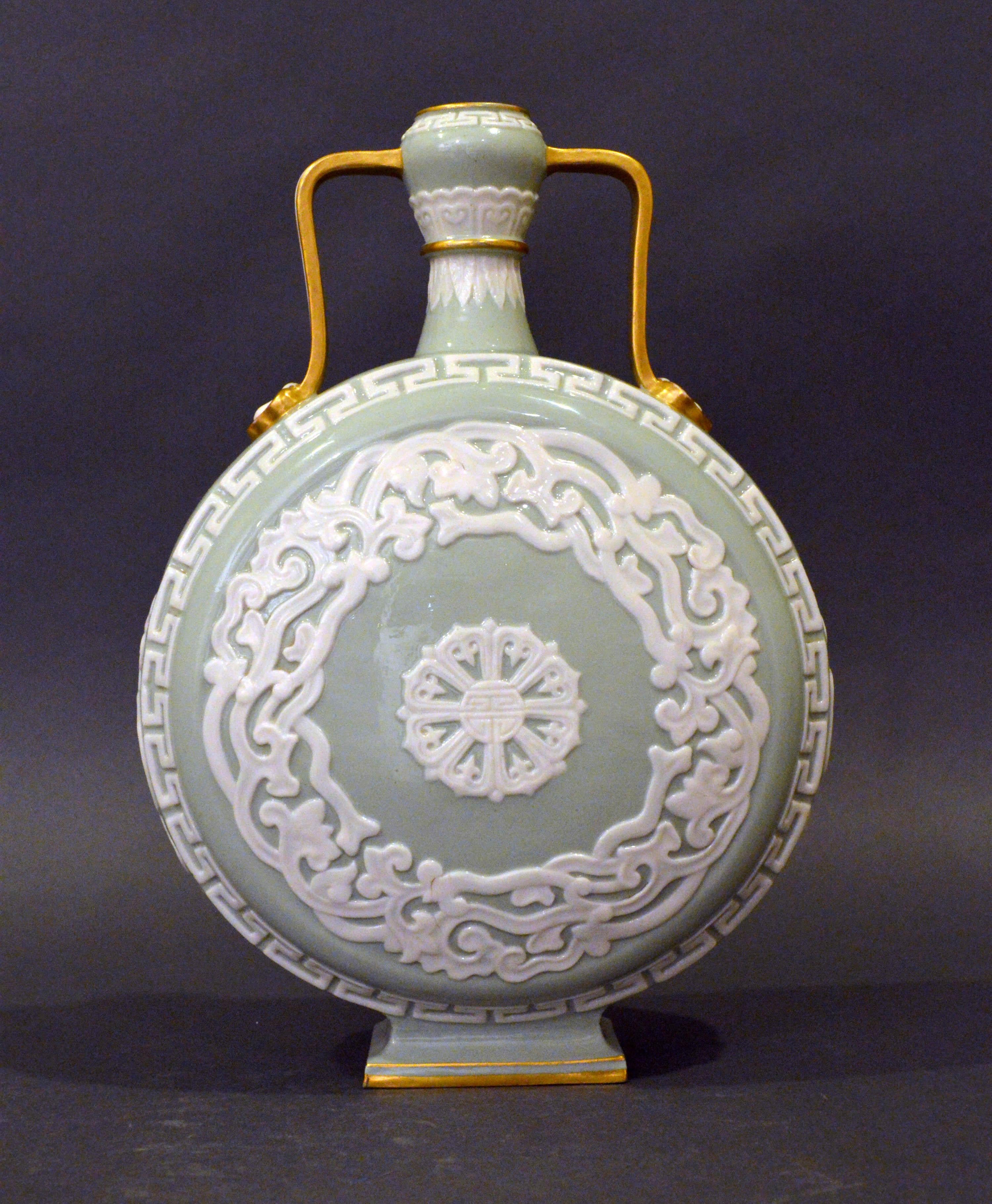 Royal Worcester porcelain moon flask,
circa 1880

Elegant Royal Worcester Porcelain chinoiserie aesthetic movement moon flask vase. A refined example of a moon flask vase in celadon green with applied white decoration and gilt covered handles.
