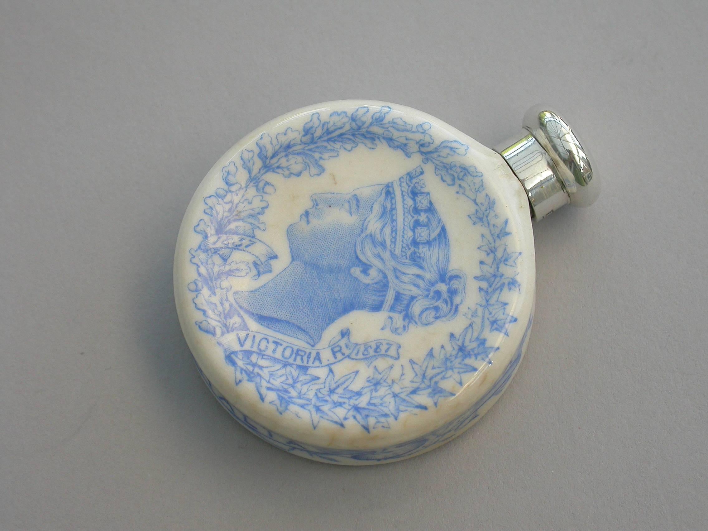 A rare Victorian silver mounted Royal Worcester porcelain scent bottle, made to celebrate Queen Victoria's golden jubilee in 1887. The blue and white transfer printed porcelain bottle features Victoria's portrait to the front and the English Rose,