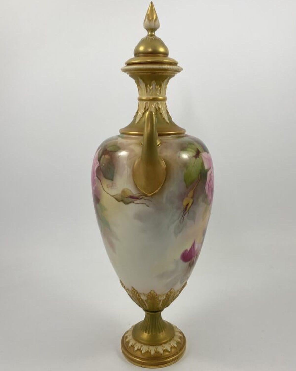 Royal Worcester porcelain vase and cover, by Jack Southall, dated 1912. The twin handled, shield shaped vase, boldly painted with studies of roses, with a smaller spray to the reverse. Having continuous acanthus leaf moulding to the neck, and the