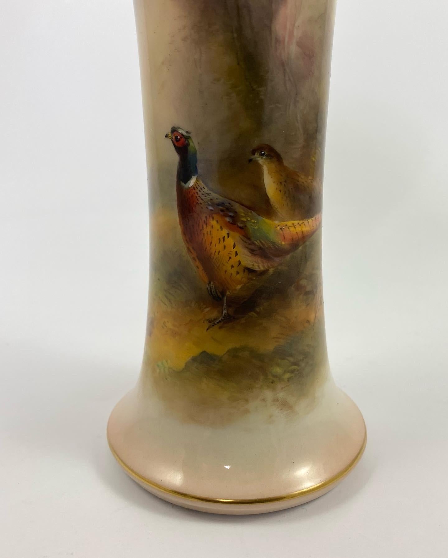 Royal Worcester porcelain vase, ‘Pheasants’, James Stinton, dated 1934. The trumpet shaped vase, finely painted by James Stinton, with pheasants in a moorland landscape, with trees in the background. Having gilt lined rims.
Signed – Jas.