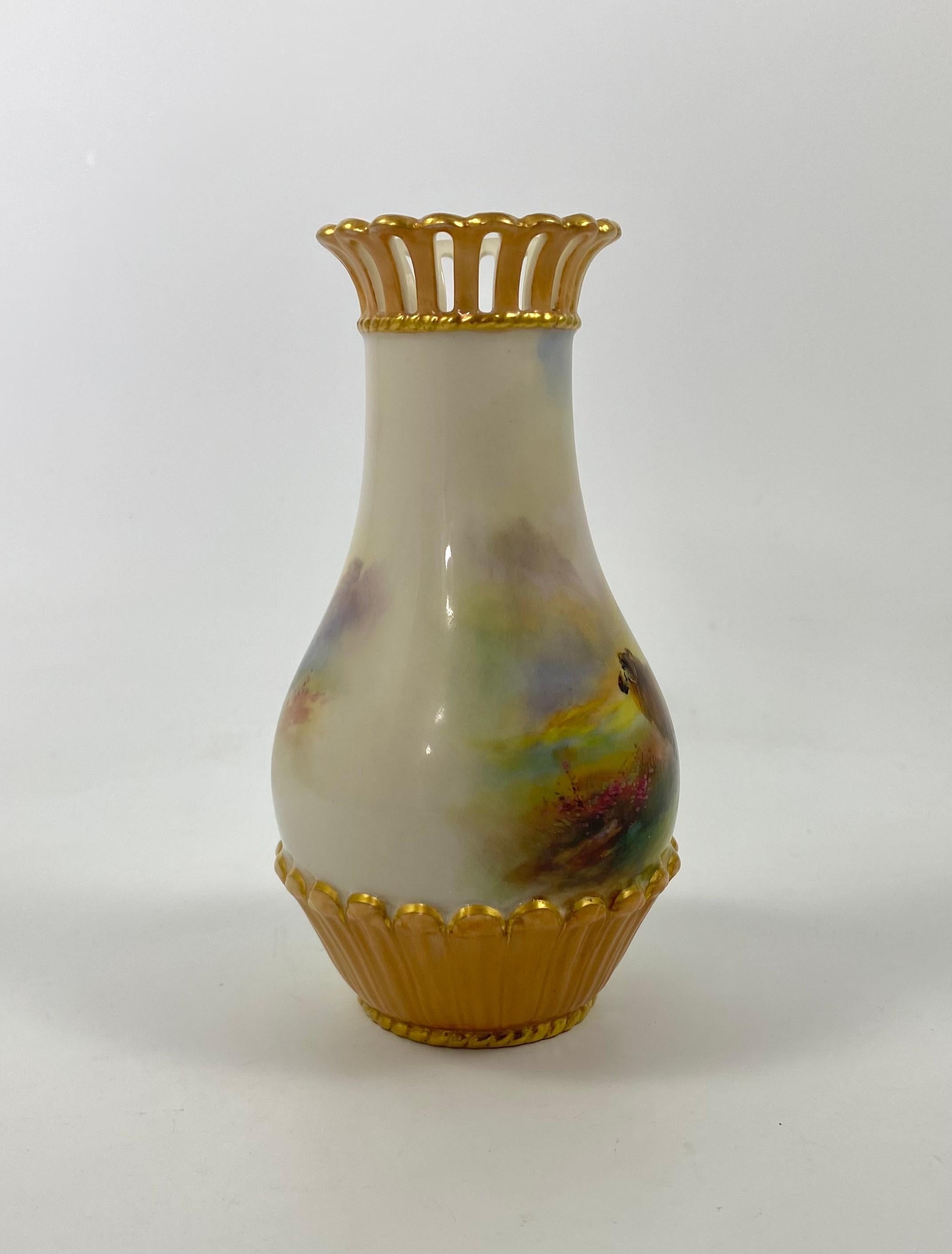 Royal Worcester porcelain vase, painted by Harry Davis, dated 1909. The body of the vase, hand painted with an atmospheric scene of sheep, in a mountainous Highland landscape. Having a moulded and reticulated rim, heightened with gilding.
Signed H.