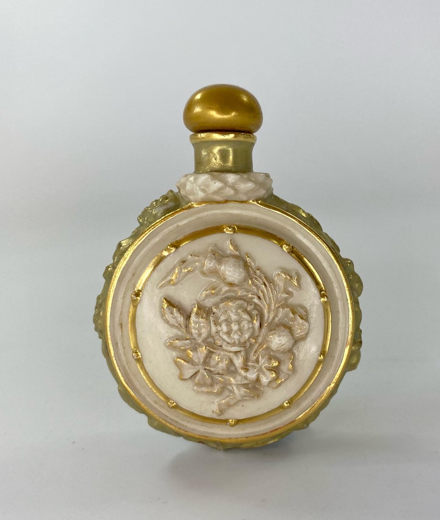 Rare Royal Worcester porcelain scent bottle and stopper, dated June 22nd 1911. Made to commemorate the Coronation of King George V, and Queen Mary. Moulded with relief profiles of the couple, and Patriotic flowers to the reverse, beneath a laurel