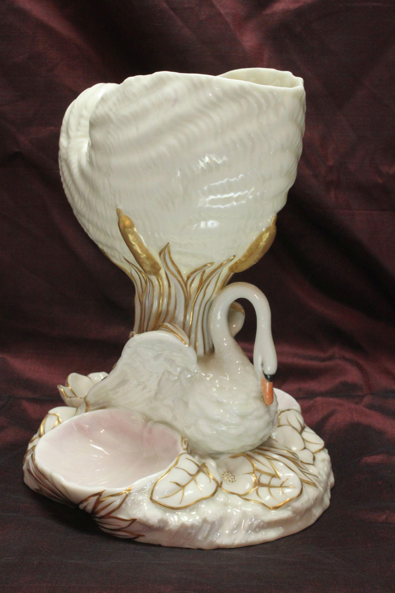 This Swan and Nautilus shell porcelain table centrepiece by Royal Worcester could also be used as a vase - either way, filled with fresh flowers it would look fabulous. The nautilus shell is supported by bulrushes and the swan, which sits amongst