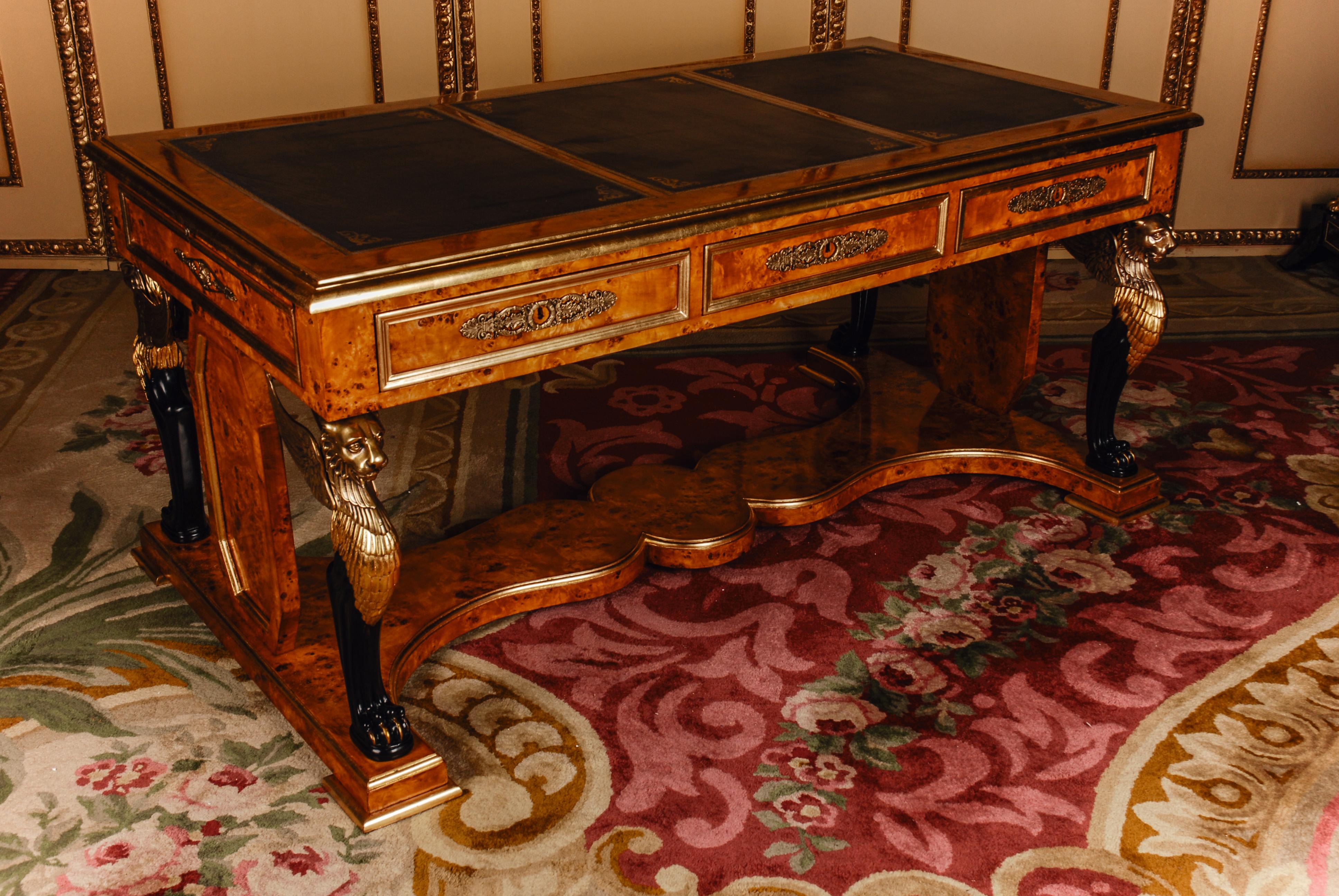 Writing table/ bureau plat in Empire style after Jacob Desmalter
Maple Roots with thread intarsia on solid Pinewood, partially carved and handpainted. Cutted out pedestal on profiled disc feet. Over which are typically large corner standing winged
