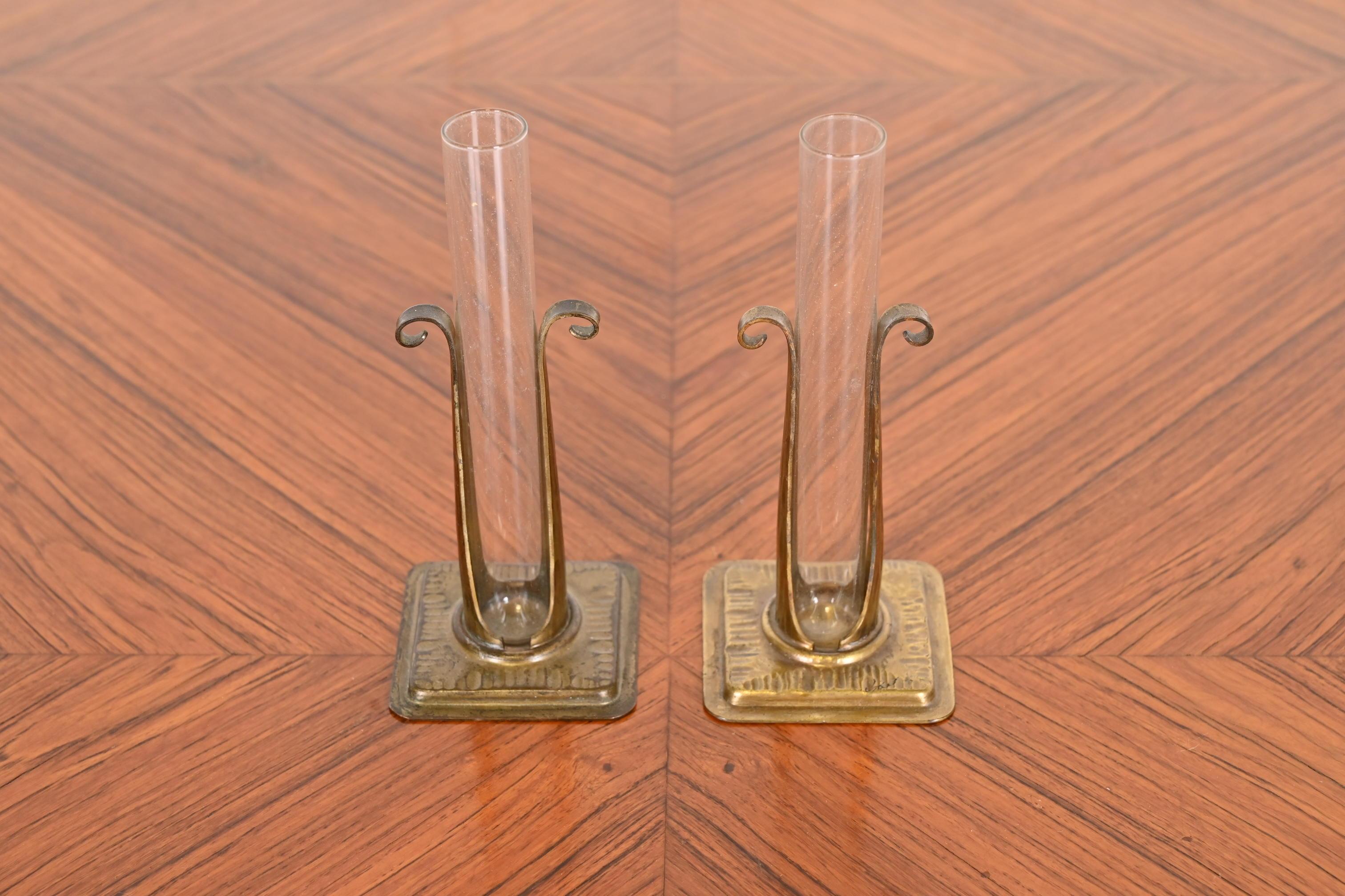 A gorgeous pair of Arts & Crafts period hand hammered copper and glass bud vases

By Roycroft (signed with impressed orb and cross mark)

USA, Early 20th Century

Each measures: 2.63
