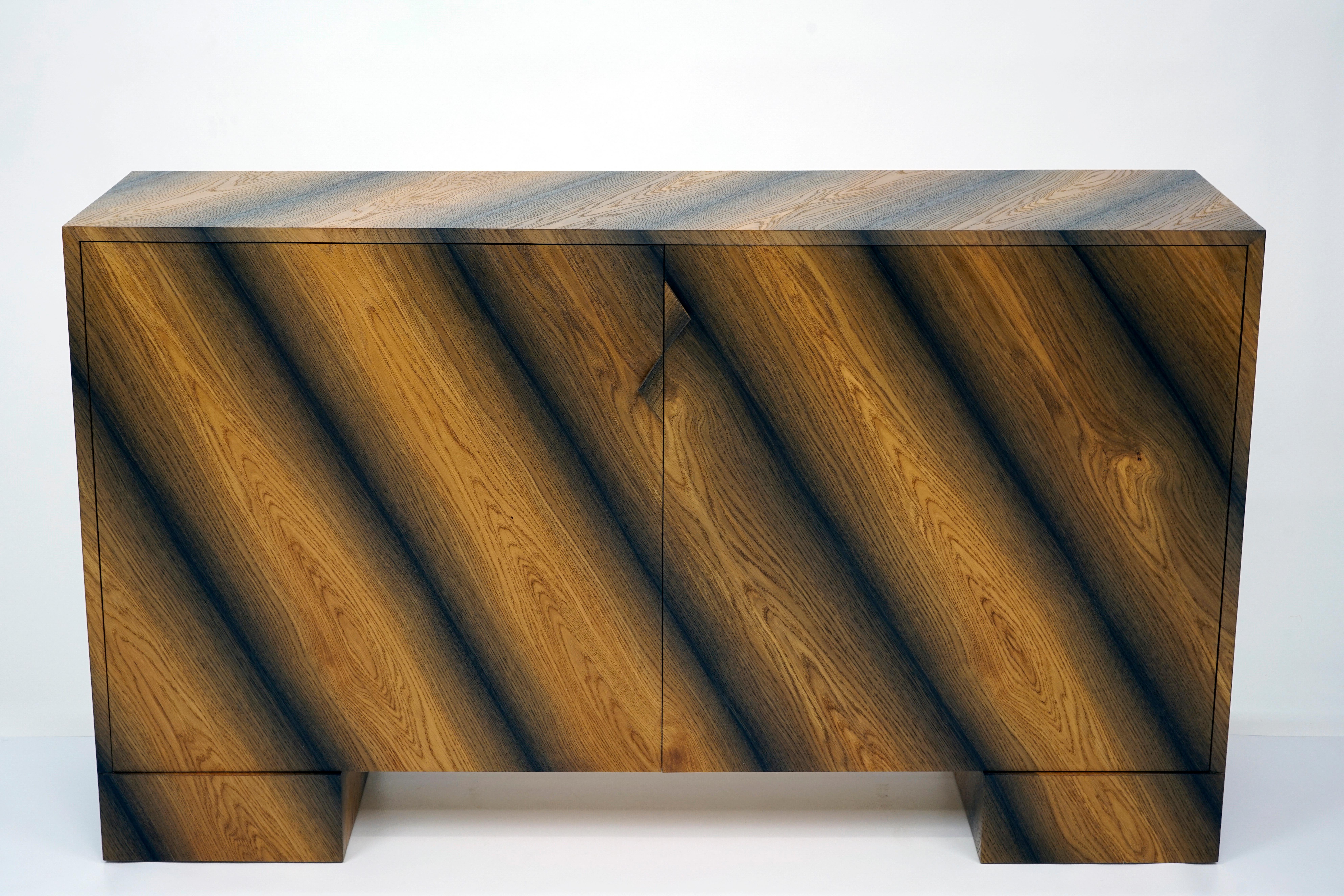Mid-Century Modern bog oak console. The stripes are formed with a natural pattern of the bog oak veneer used. The result is a stunning marriage of Classic design with the beauty of one of nature’s most remarkable gifts. Carbon dated 1200 years old,