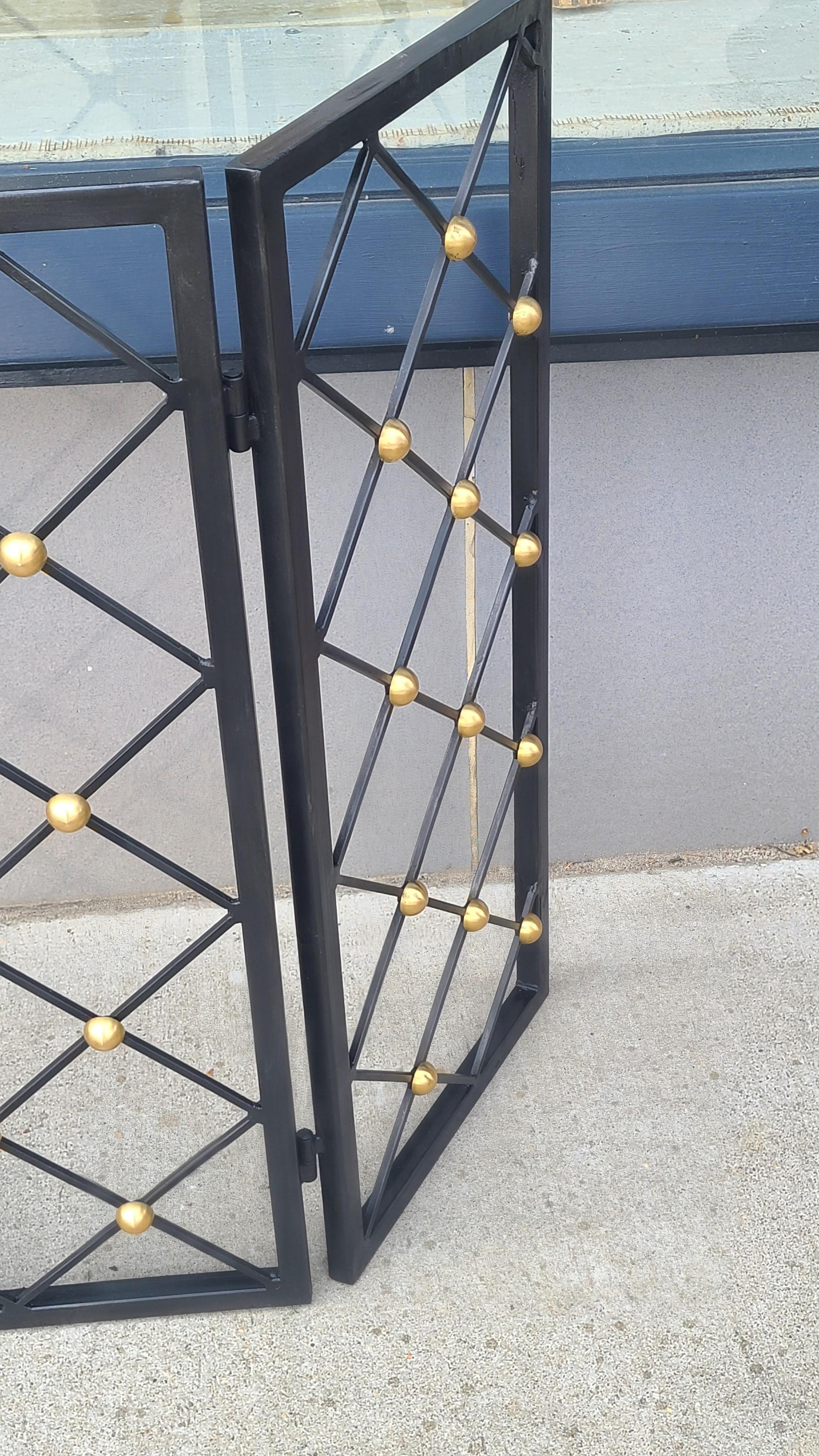 This iron and brass screen in the style of Jean Royere was a custom made fire place screen. There is no actual screen as this was used more to block the fireplace when not in use.