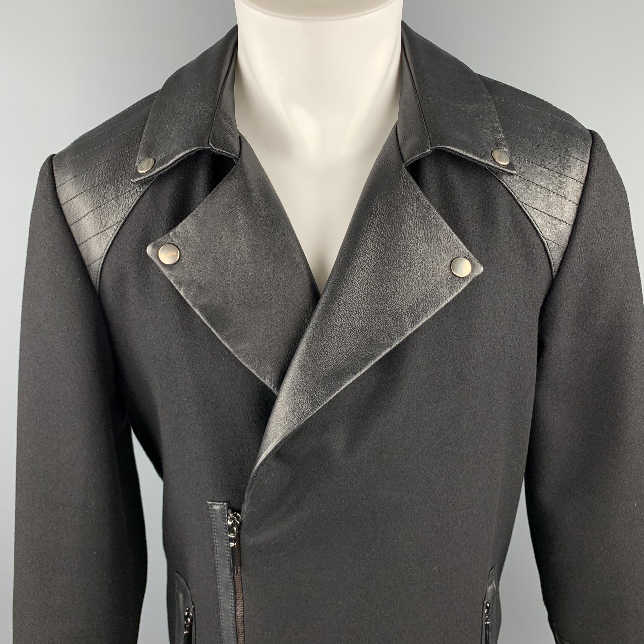 ROYGBM Artful Gentleman coat comes in black wool  with an asymmetrical zip closure, zip pockets, and leather quilted shoulders, cuffs, and biker lapel.  Made in USA.

Excellent Pre-Owned Condition.
Marked: M

Measurements:

Shoulder: 18 in.
Chest: