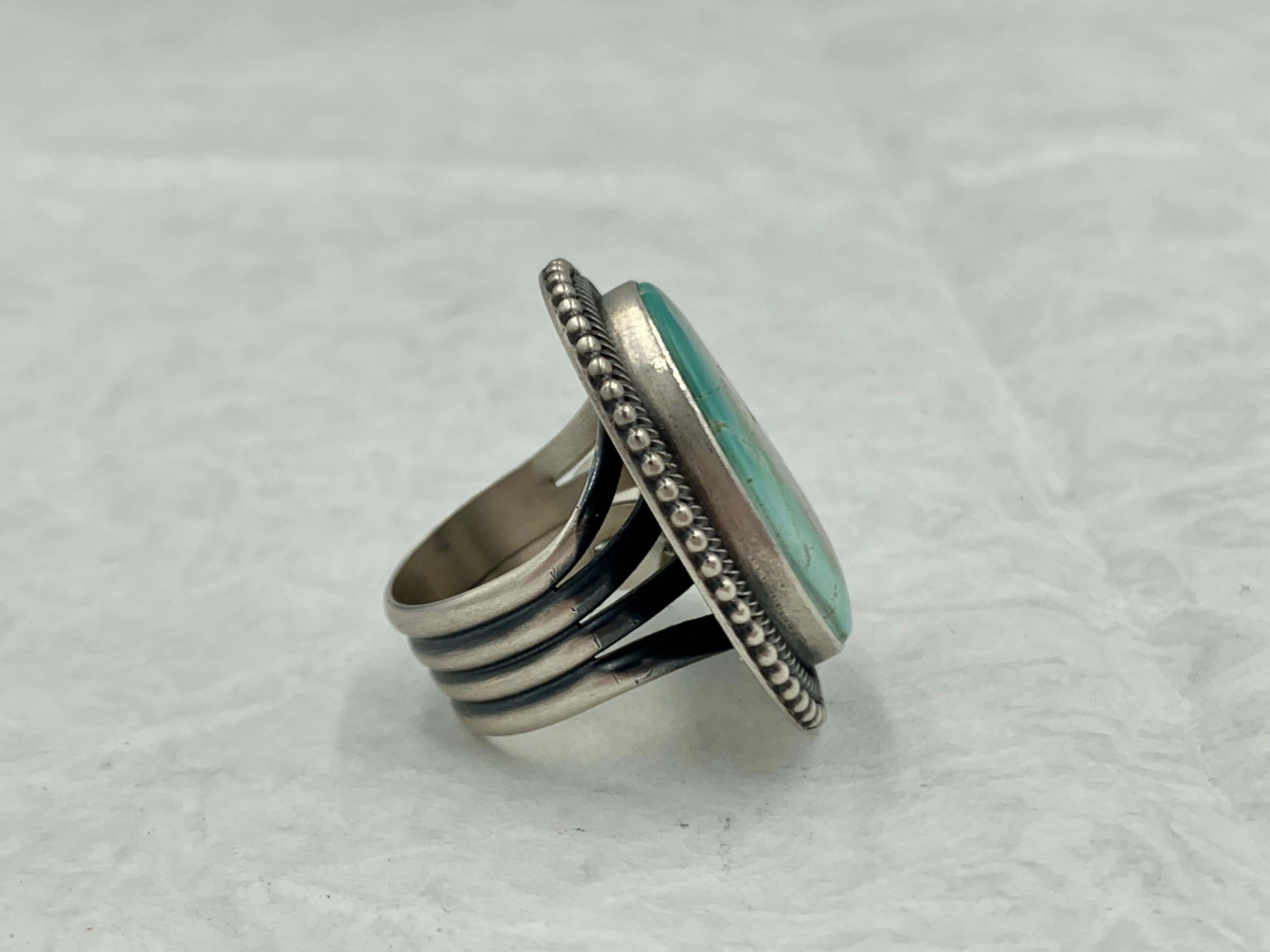 Sterling silver ring by Navajo silversmith Ernest Ray Begay. A smooth bezel, twisted wire and bead wire focuses your attention on the 3/4” x 1” Royston turquoise stone.

Ernest’s career in jewelry making didn’t really take off until he entered some