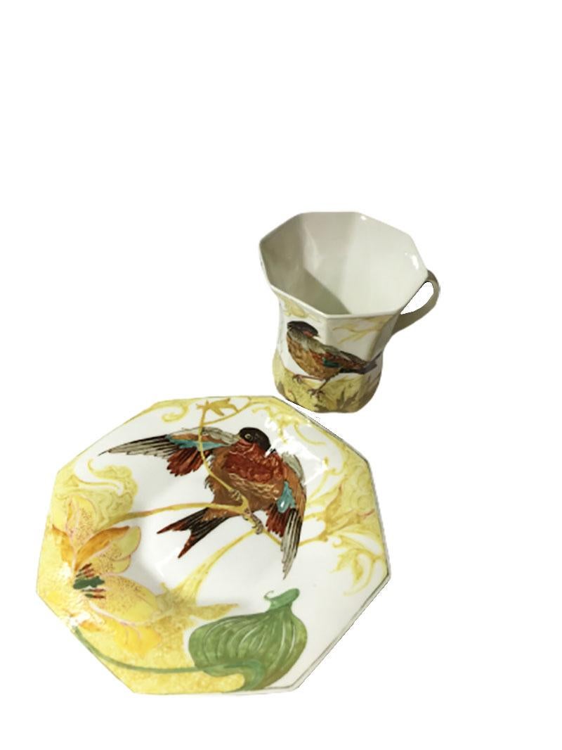 Rozenburg egg-shell cup and saucer with bird and floral decor, 1913.
 
Rozenburg, NV Haagsche Plateelbakkerij/Koninklijke Porselein- en Aardewerkfabriek
(Den Haag 1883-1917)

Size of the cup is 5.7 cm high and 5.5 cm wide (with ear is 6.5)
The