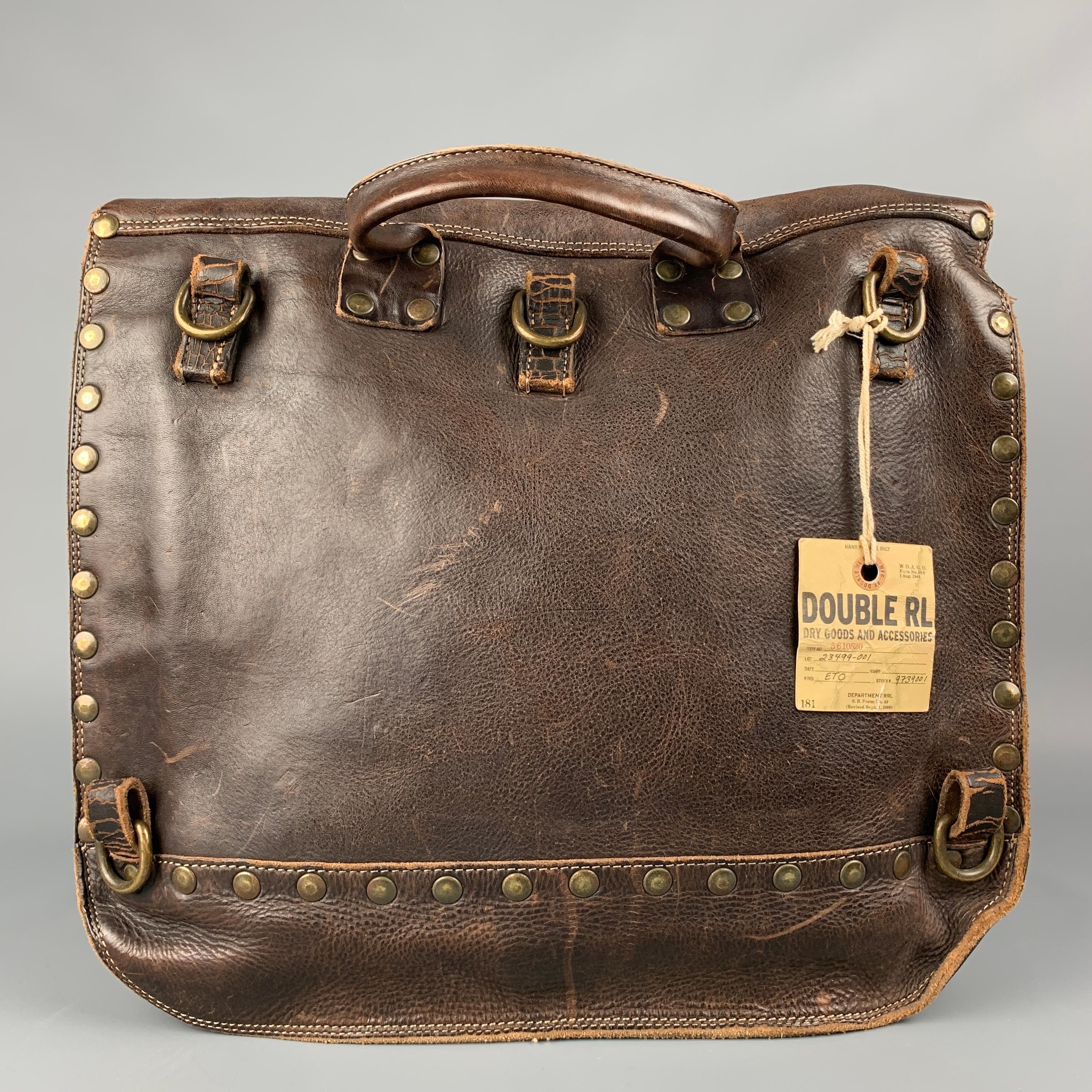 RRL by RALPH LAUREN Limited Edition bag comes in a brown distressed leather featuring studded details, top handle, inner compartment, and a double buckle strap closure. 

New With Tags. 

Measurements:

Length: 13.5 in.
Width: 4 in.
Height: 12