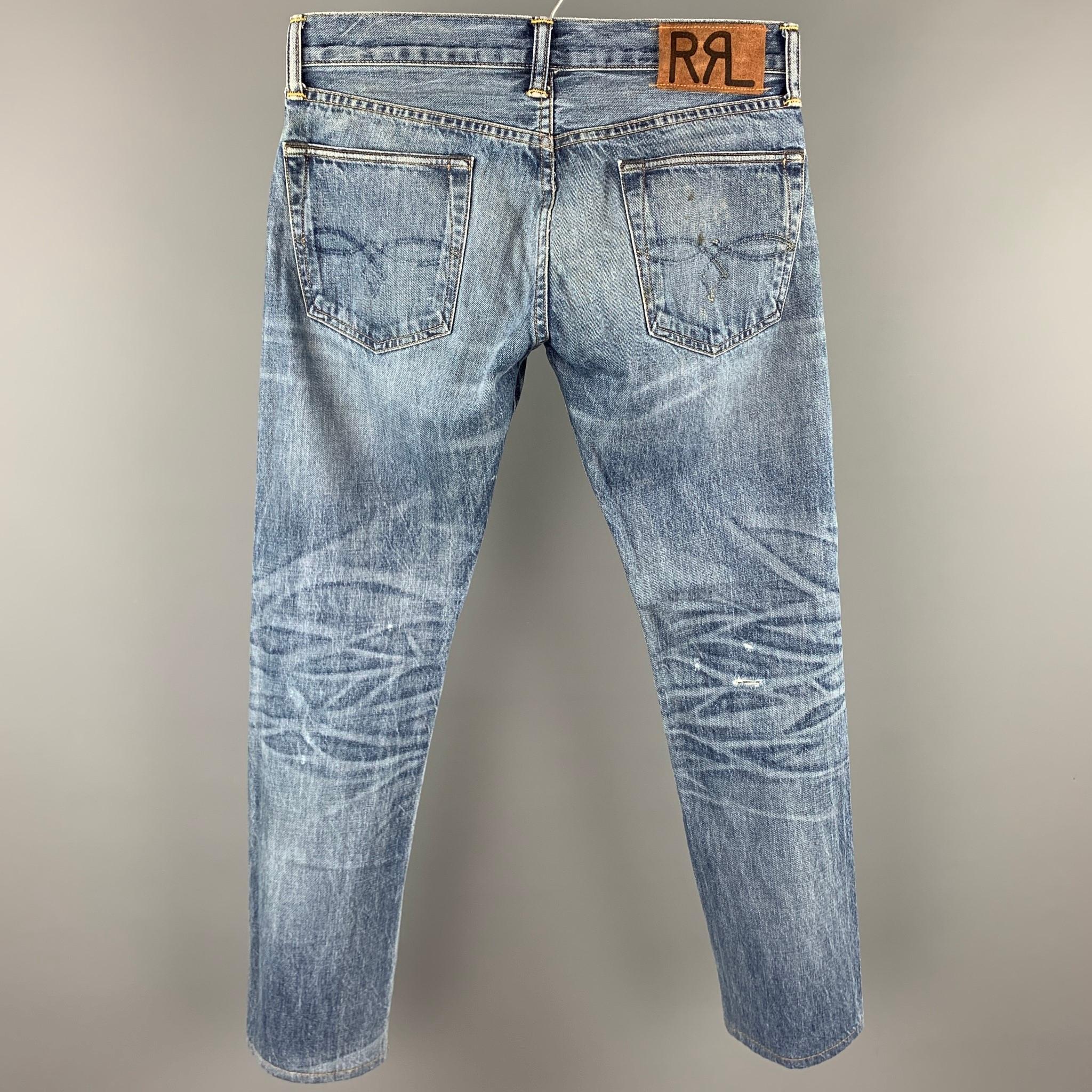 RRL by RALPH LAUREN jeans comes in a light blue washed selvedge denim featuring a low straight fit, distressed, contrast stitching, and a button fly closure. Made in USA.

Good Pre-Owned Condition.
Marked: 28x32

Measurements:

Waist: 30 in.
Rise: