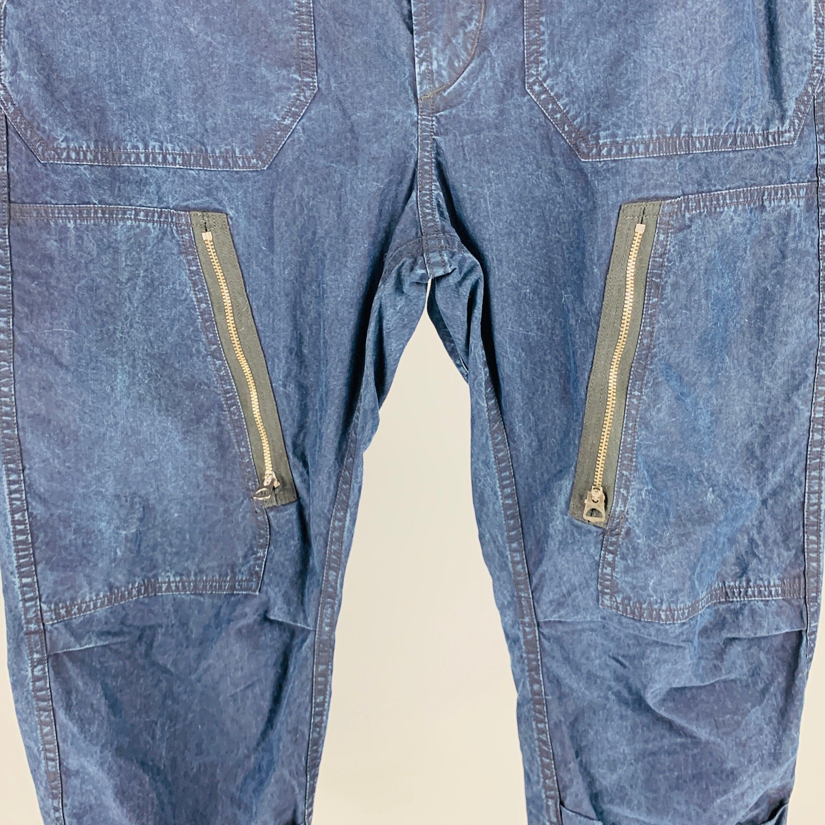 RRL by RALPH LAUREN casual pants
in an indigo wash lyocell blend fabric featuring zip pockets, drawstring cuffs, and zip fly closure. Excellent Pre-Owned Condition. 

Marked:   32 

Measurements: 
  Waist: 32 inches Rise: 11.5 inches Inseam: 29