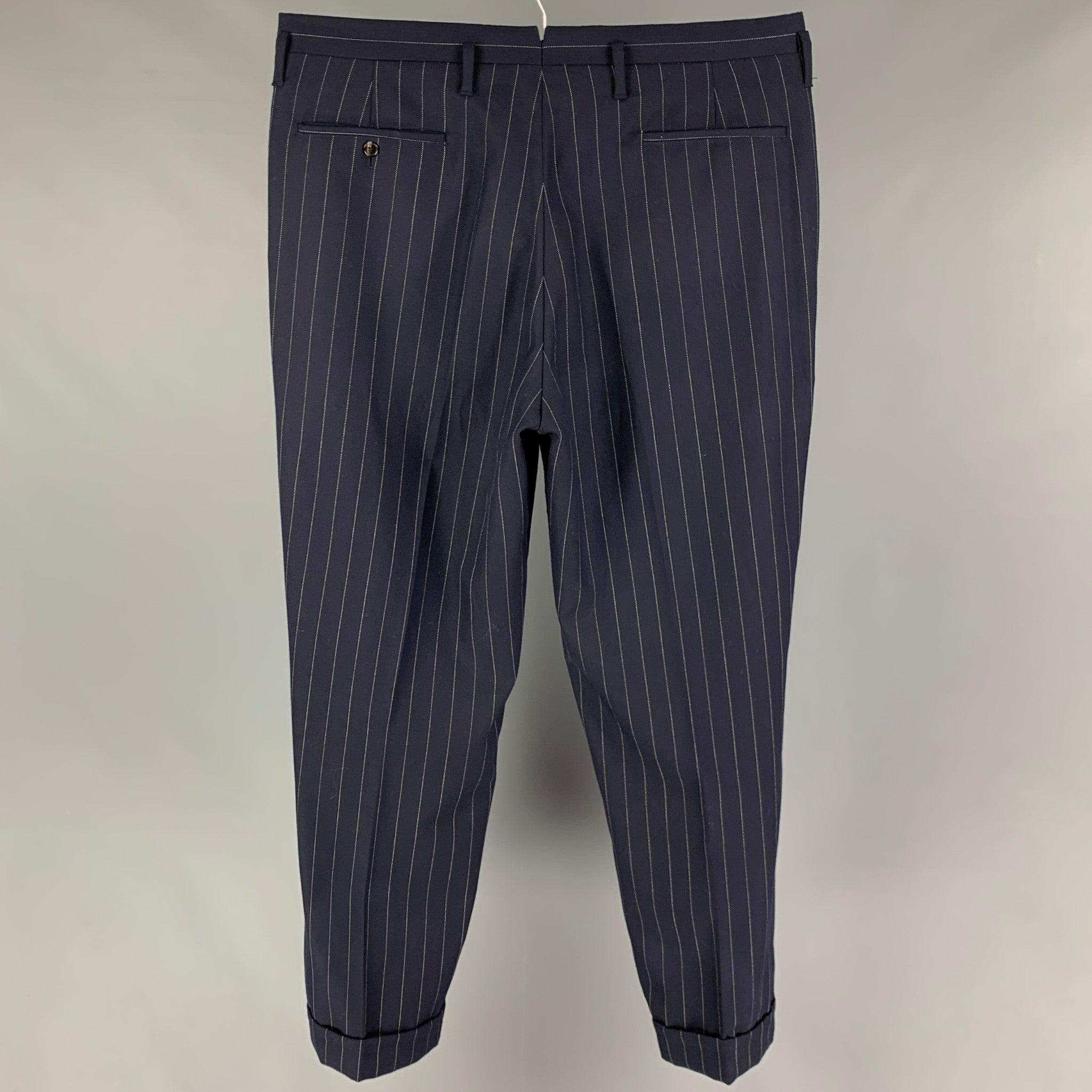 RRL by RALPH LAUREN pants comes in a navy pinstripe wool featuring a flat front, cuffed leg, front tab, and a button fly closure.
 Very Good
 Pre-Owned Condition. 
 

 Marked:  36 
 

 Measurements: 
  Waist: 38 inches Rise: 13.5 inches Inseam: 31
