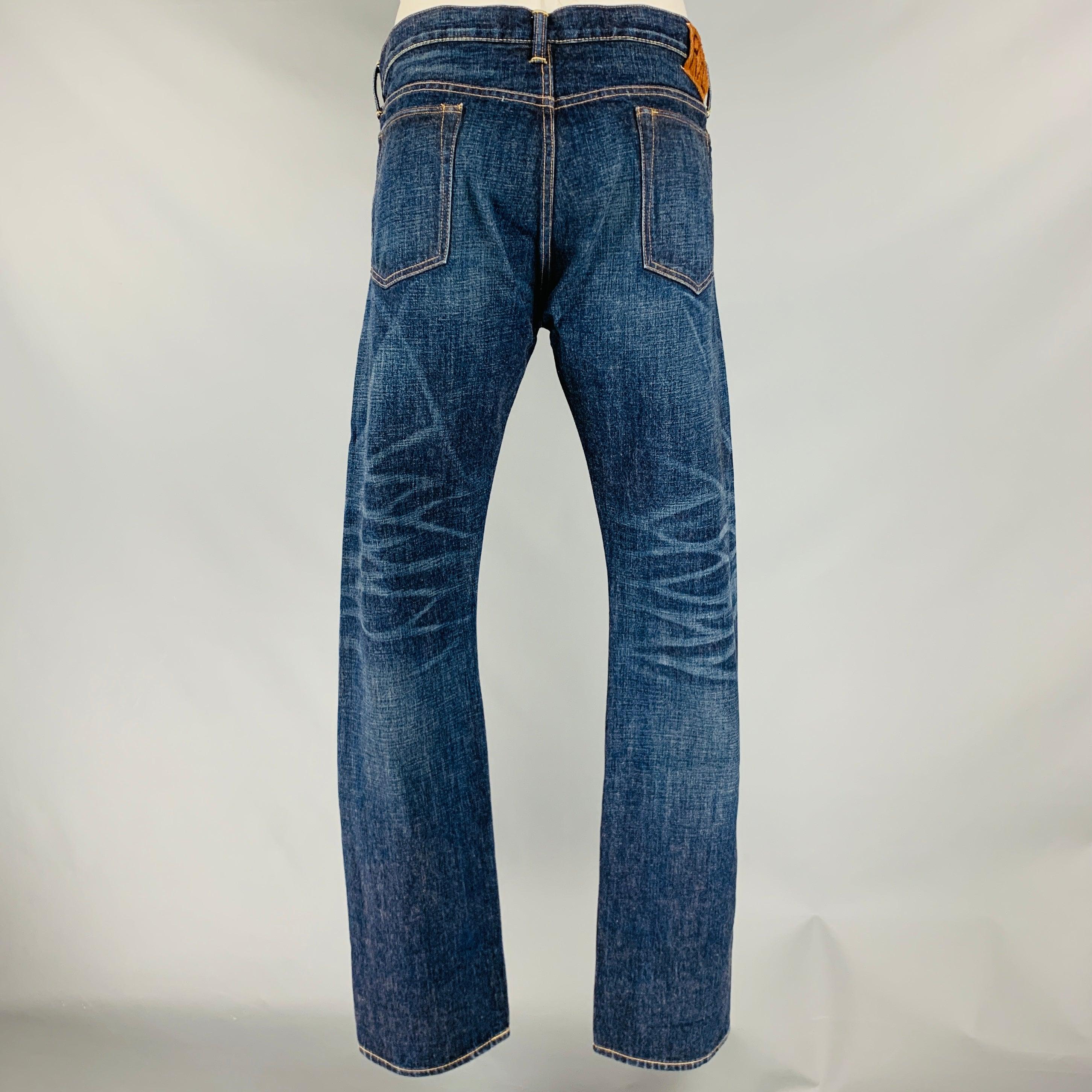 RRL by RALPH LAUREN jeans
in an indigo selvedge denim cotton featuring yellow contrast stitching, five pockets style, and button fly closure. Made in USA.New without Tags. 

Marked:   38/34 

Measurements: 
  Waist: 38 inches Rise: 10 inches Inseam: