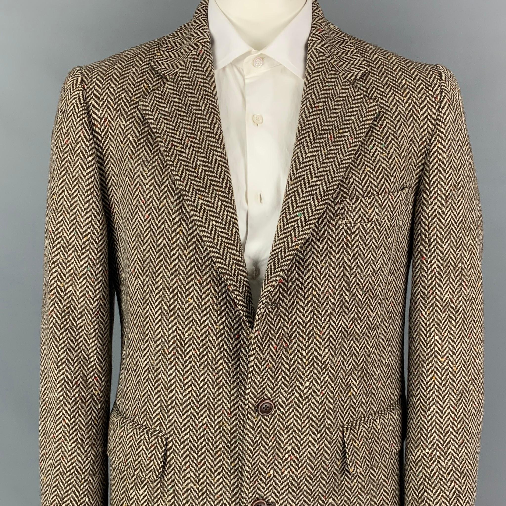 RRL by RALPH LAUREN sport coat comes in a brown & beige herringbone wool with a full liner featuring a notch lapel, flap pockets, and a three button closure. Made in USA. 

Very Good Pre-Owned Condition.
Marked: L

Measurements:

Shoulder: 18.5