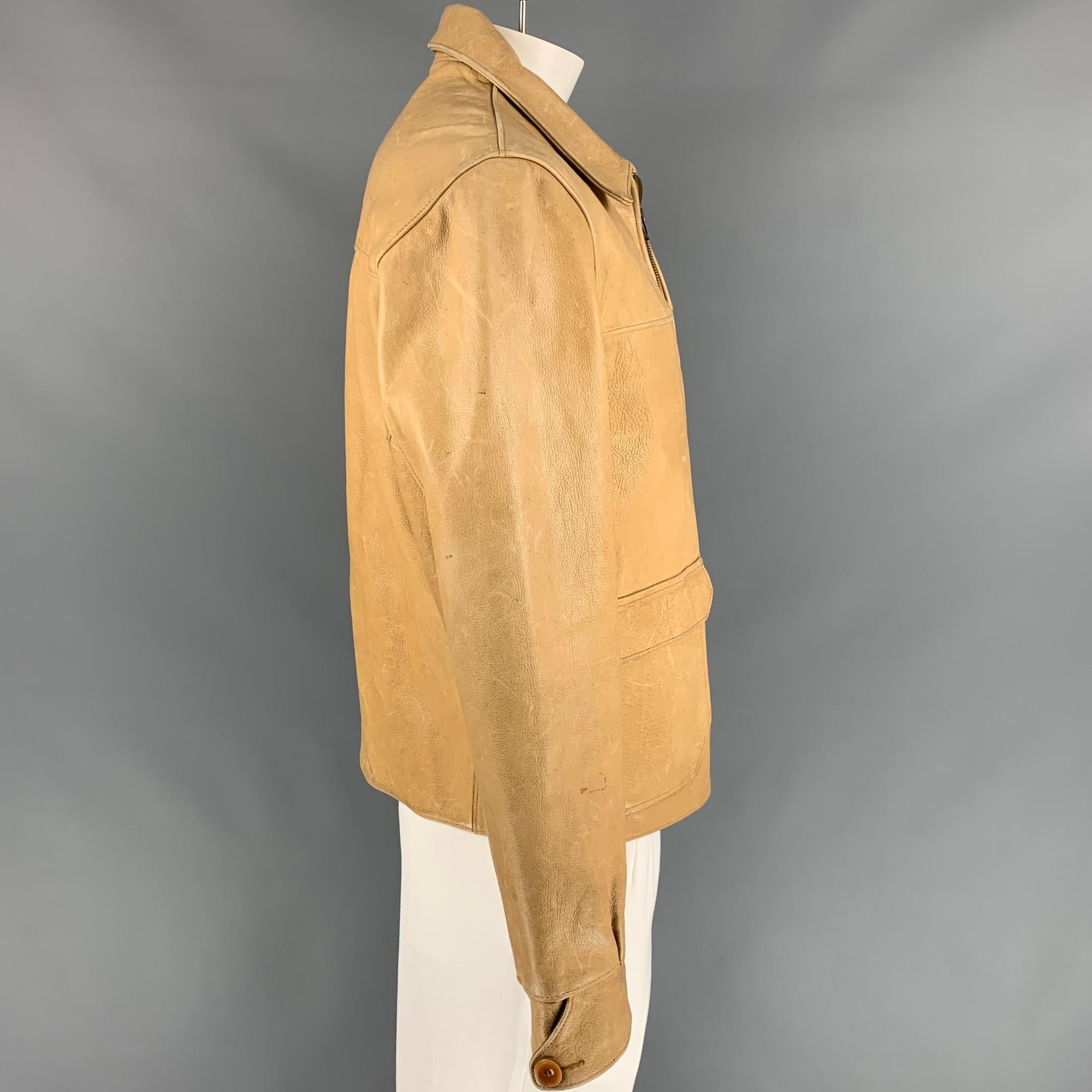 RRL by RALPH LAUREN jacket comes in a beige leather with a plaid liner featuring large flap pockets, pointed collar, and a full zip up closure. 

Good Pre-Owned Condition.
Marked: L
Original Retail Price: $1,800.00

Measurements:

Shoulder: 20