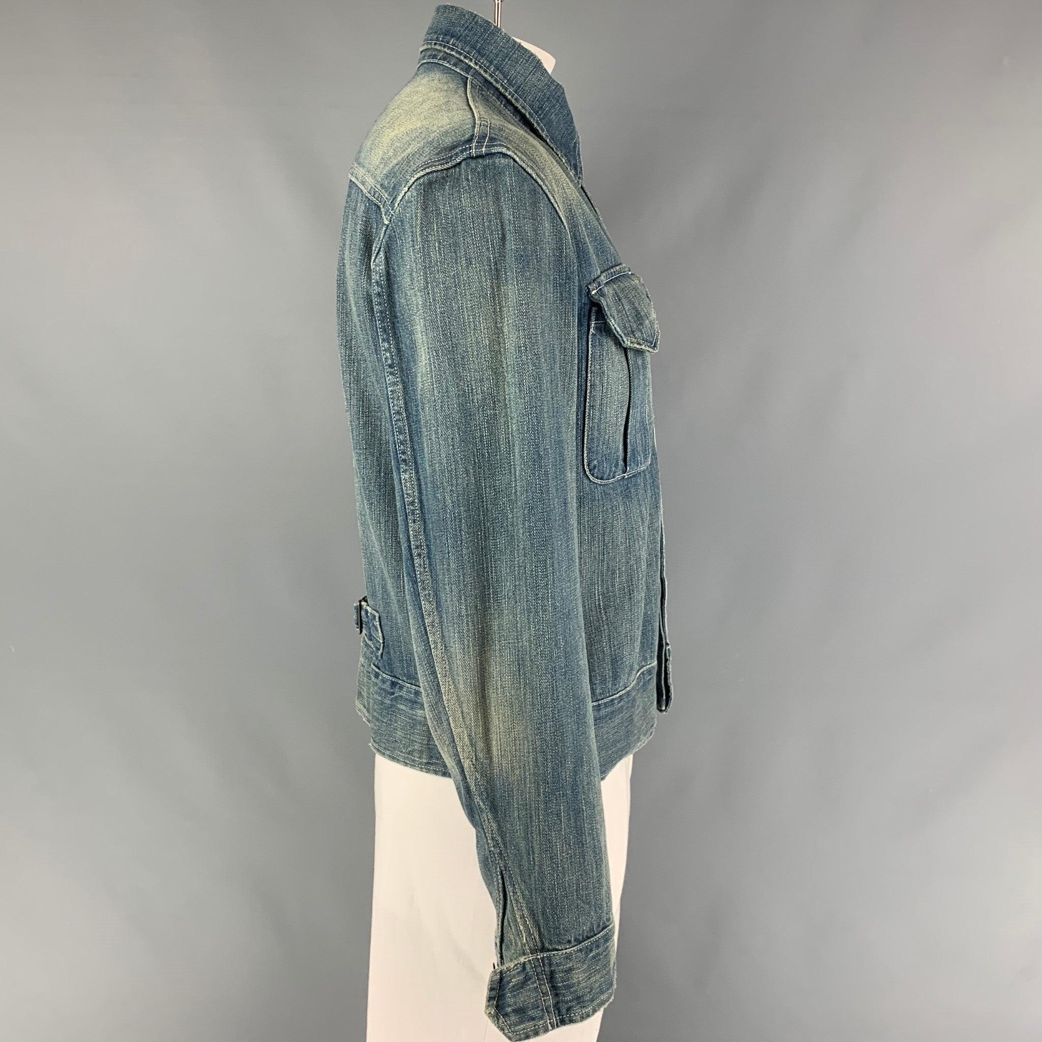 RRL by RALPH LAUREN jacket comes in a blue distressed cotton featuring two large front pockets, spread collar, contrast stitching, back strap detail, and a hidden placket closure.
Very Good Pre-Owned Condition.  

Marked:   L  

Measurements: 

