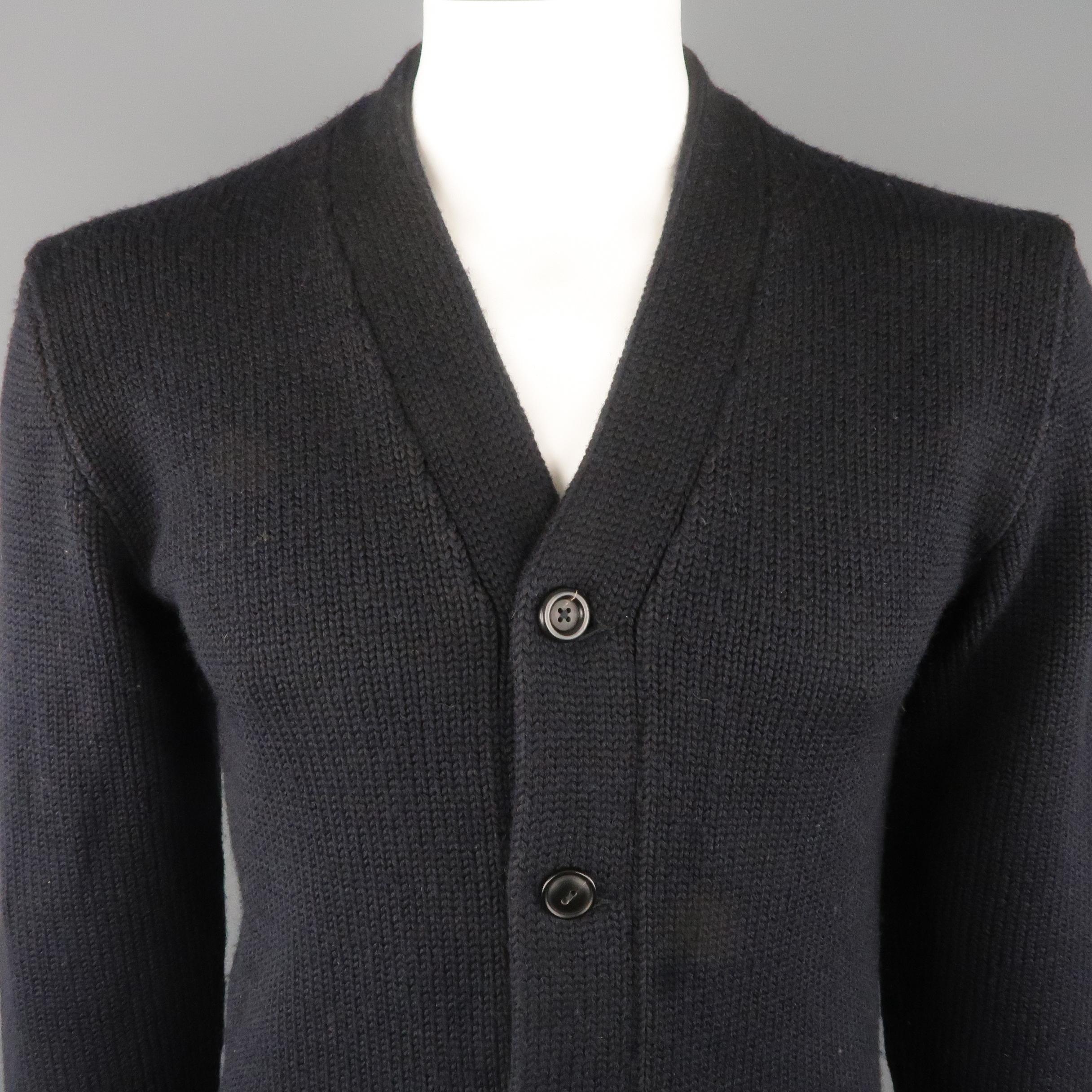 RRL by RALPH LAUREN Cardigan Sweater comes in a navy  tone in a knitted wool  material, with 5 buttons at closure, slit pockets, a front and arm patches, leather elbow patches, and ribbed cuffs and hem.
 
Excellent Pre-Owned Condition.
Marked: M
