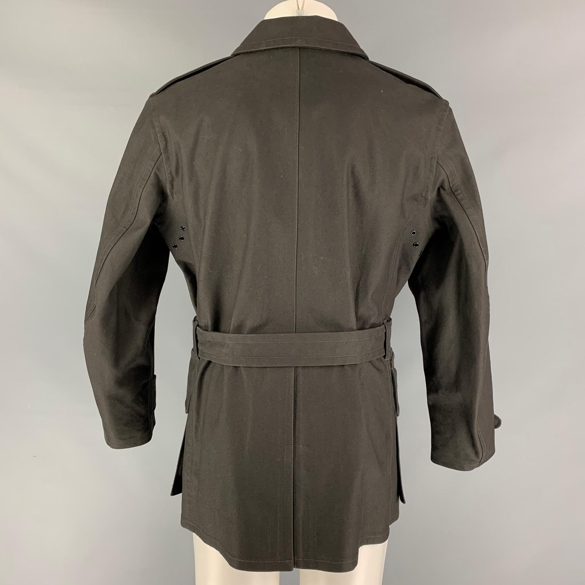 RRL by RALPH LAUREN coat comes in a olive cotton with a plaid liner featuring contrast stitching, patch pockets, belted, and a buttoned closure. 

Very Good Pre-Owned Condition.
Marked: M

Measurements:

Shoulder: 18 in.
Chest: 44 in.
Sleeve: 24.5