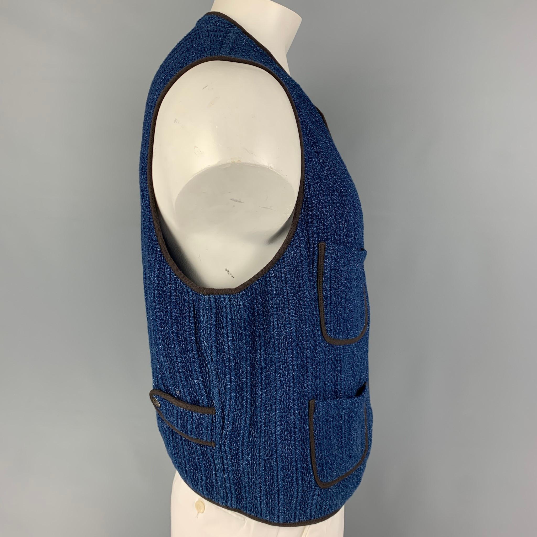 RRL by RALPH LAUREN vest comes in a blue knitted cotton featuring a black trim featuring patch pockets and a snap buttoned closure. 

Very Good Pre-Owned Condition.
Marked: XL

Measurements:

Shoulder: 17 in.
Chest: 46 in.
Length: 21.5 in. 