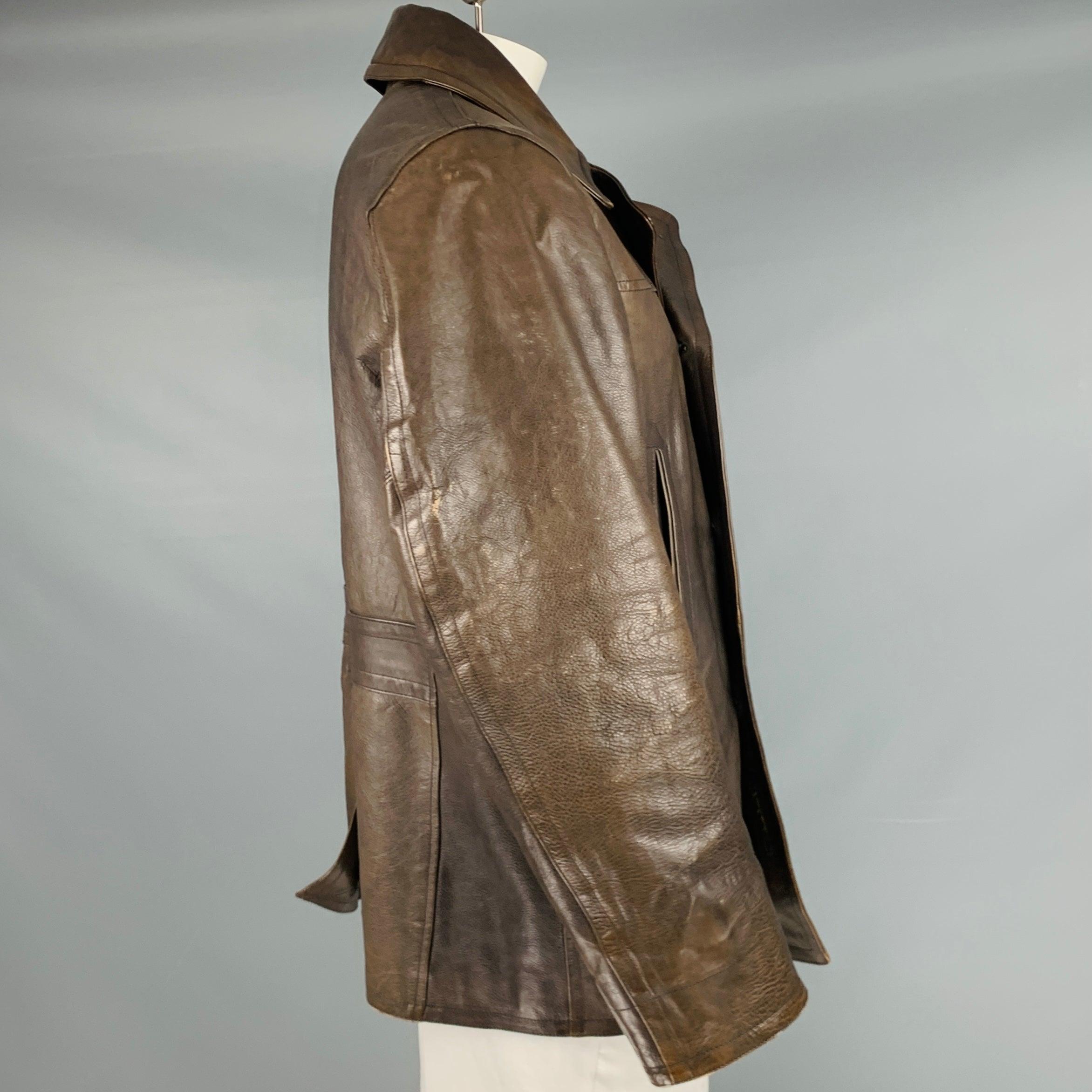 RRL by RALPH LAUREN coat
in a brown leather fabric featuring a double breasted peacoat style, two slit pockets, and button closure.Very Good Pre-Owned Condition. Moderate signs of wear. 

Marked:   XL 

Measurements: 
 
Shoulder: 19 inches Chest: 44