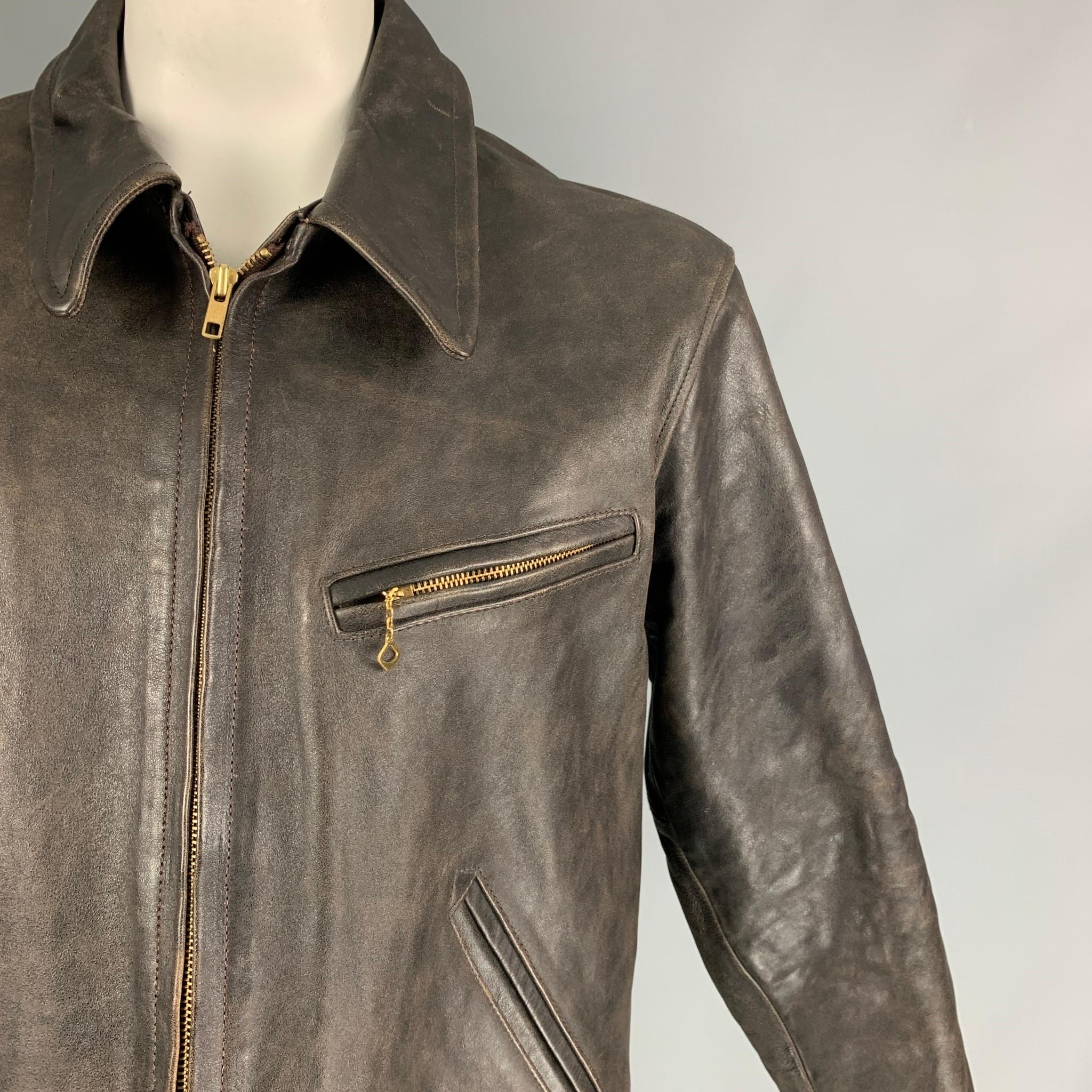 RRL by RALPH LAUREN jacket comes in a dark brown distressed leather with a plaid liner featuring a spread collar, front zipper pockets, and a full zip up closure. 

Very Good Pre-Owned Condition.
Marked: XL

Measurements:

Shoulder: 20 in.
Chest: 46