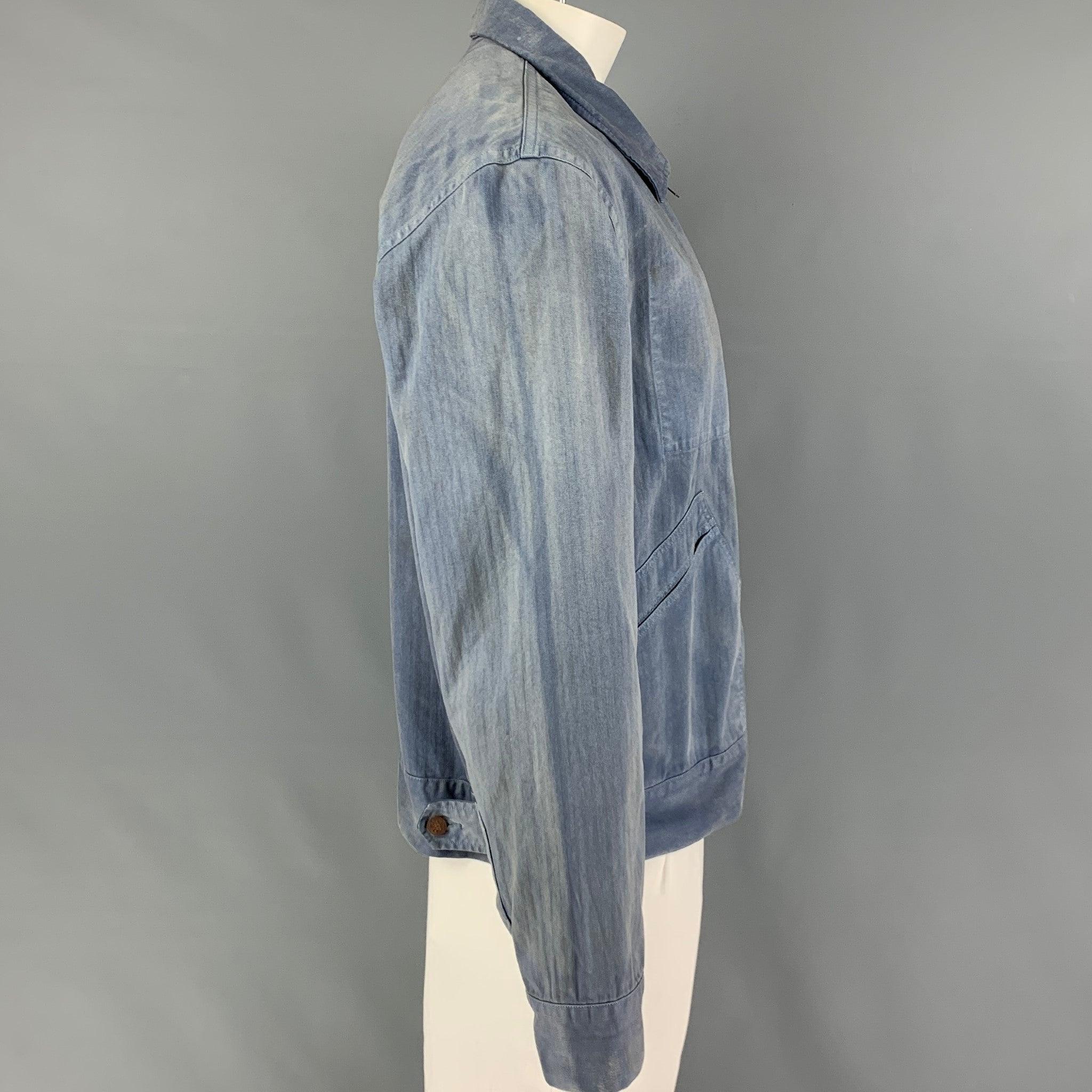 RRL by RALPH LAUREN jacket comes in a light blue washed cotton featuring a sleeve patch detail, front pockets, spread collar, and a full zip up closure.
Very Good
Pre-Owned Condition. 

Marked:   XL 

Measurements: 
 
Shoulder: 21 inches  Chest: 46