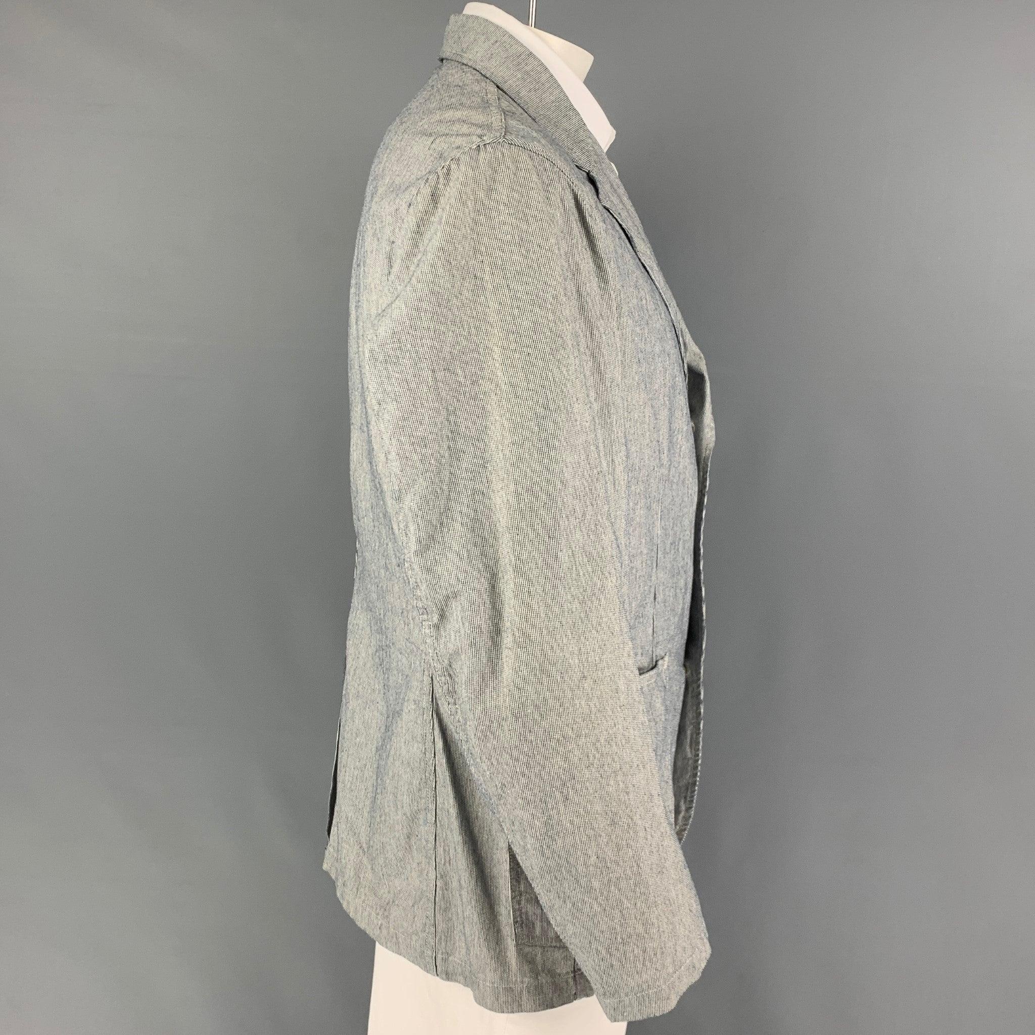 RRL by RALPH LAUREN
sport coat comes in a white & navy stripe cotton featuring a notch lapel, patch pockets, single back vent, and a three button closure.Very Good Pre-Owned Condition.  

Marked:   XL  

Measurements: 
 
Shoulder: 19 inches  Chest: