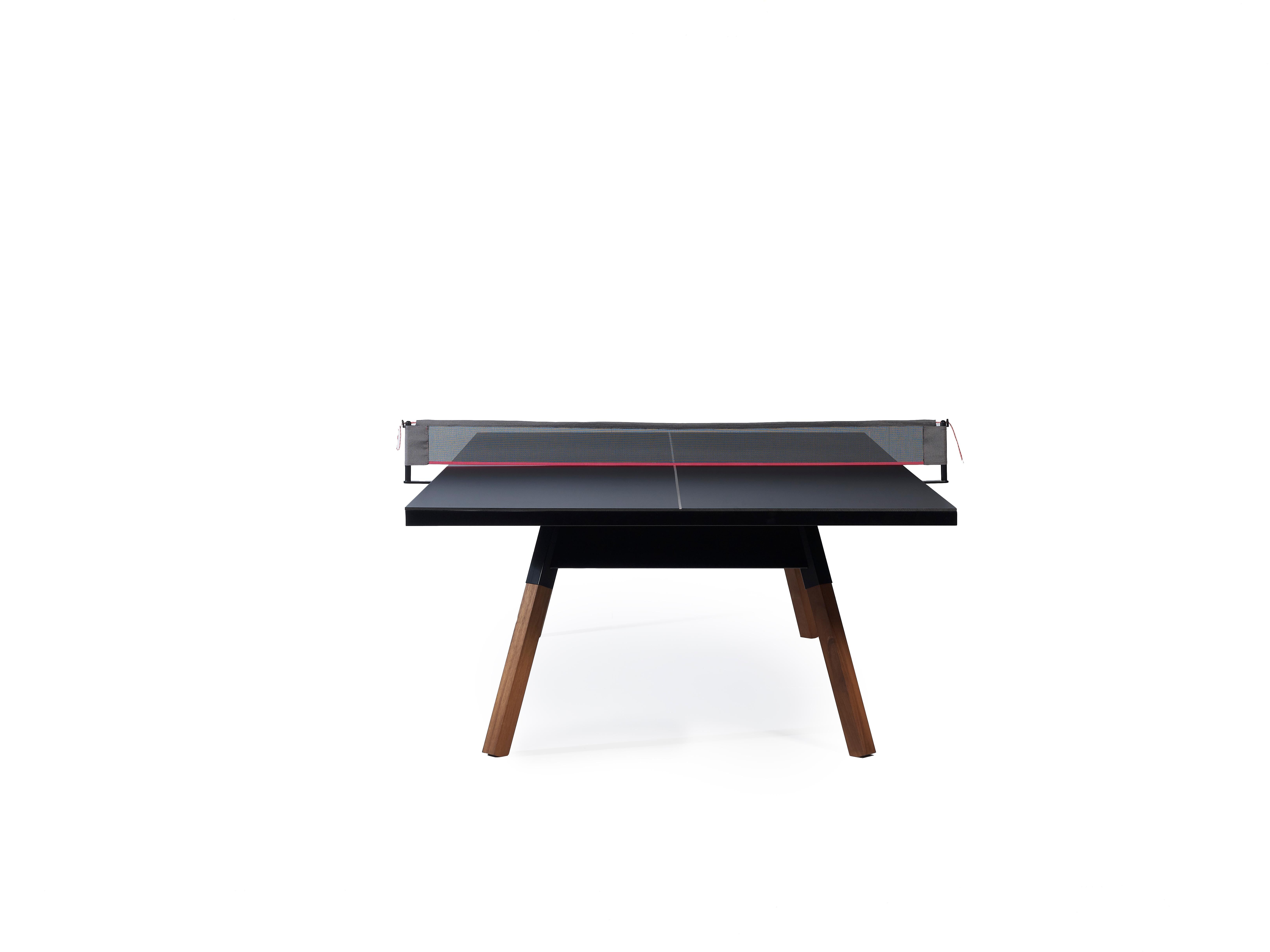 The  You and Me ping-pong table is a standard sized game table that doubles as a dining or conference table. All the sportiness that it gets from the net, the bats, and the balls, can be put in the side drawer and hidden away completely. Built from