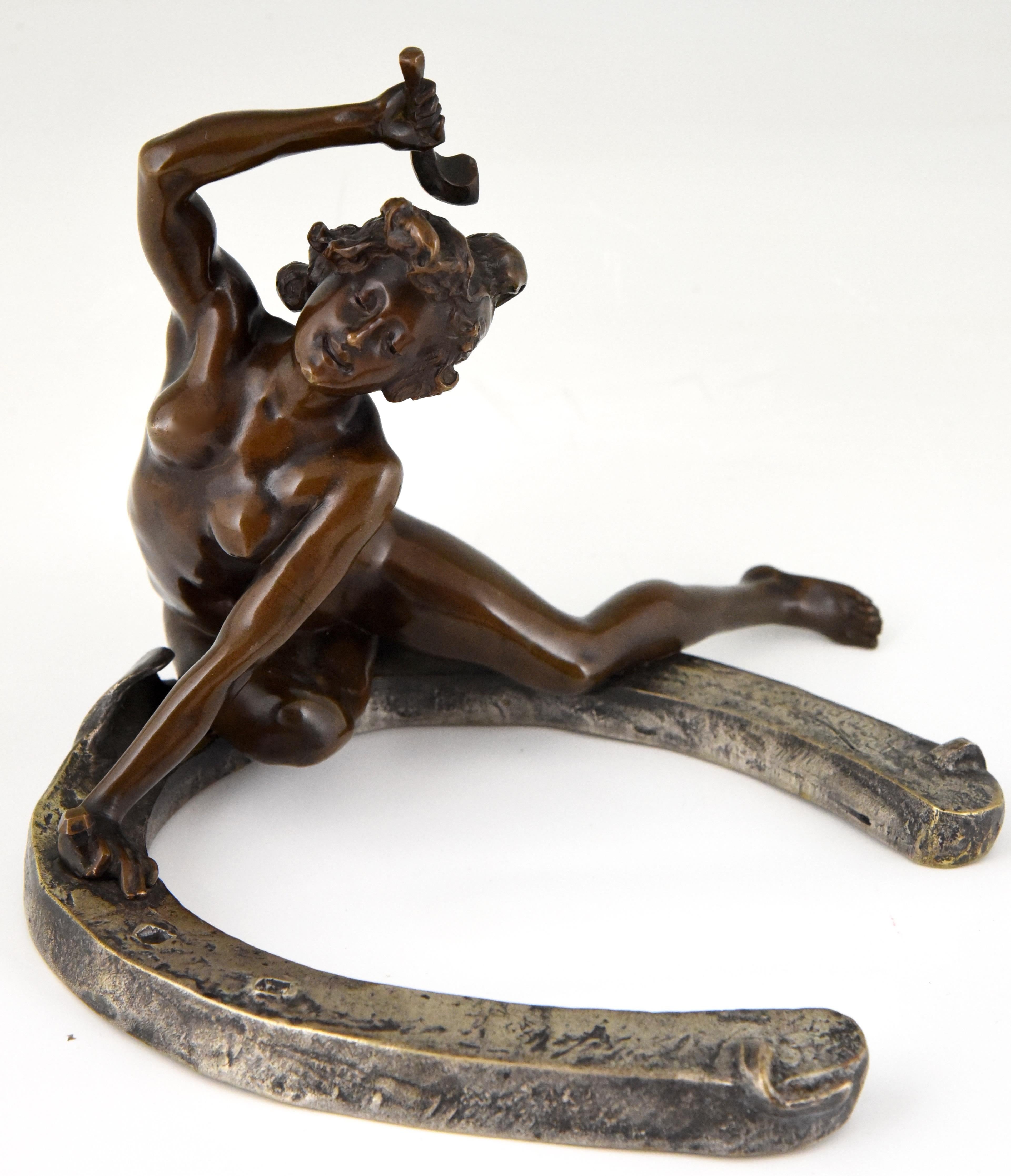 Art Nouveau bronze sculpture of a nude sitting on a horseshoe. The bronze is signed by the French artist Geroges Récipon and stamped by the founder Susse Freres. The bronze has a lovely patina. This model exists in two sizes, this is the largest