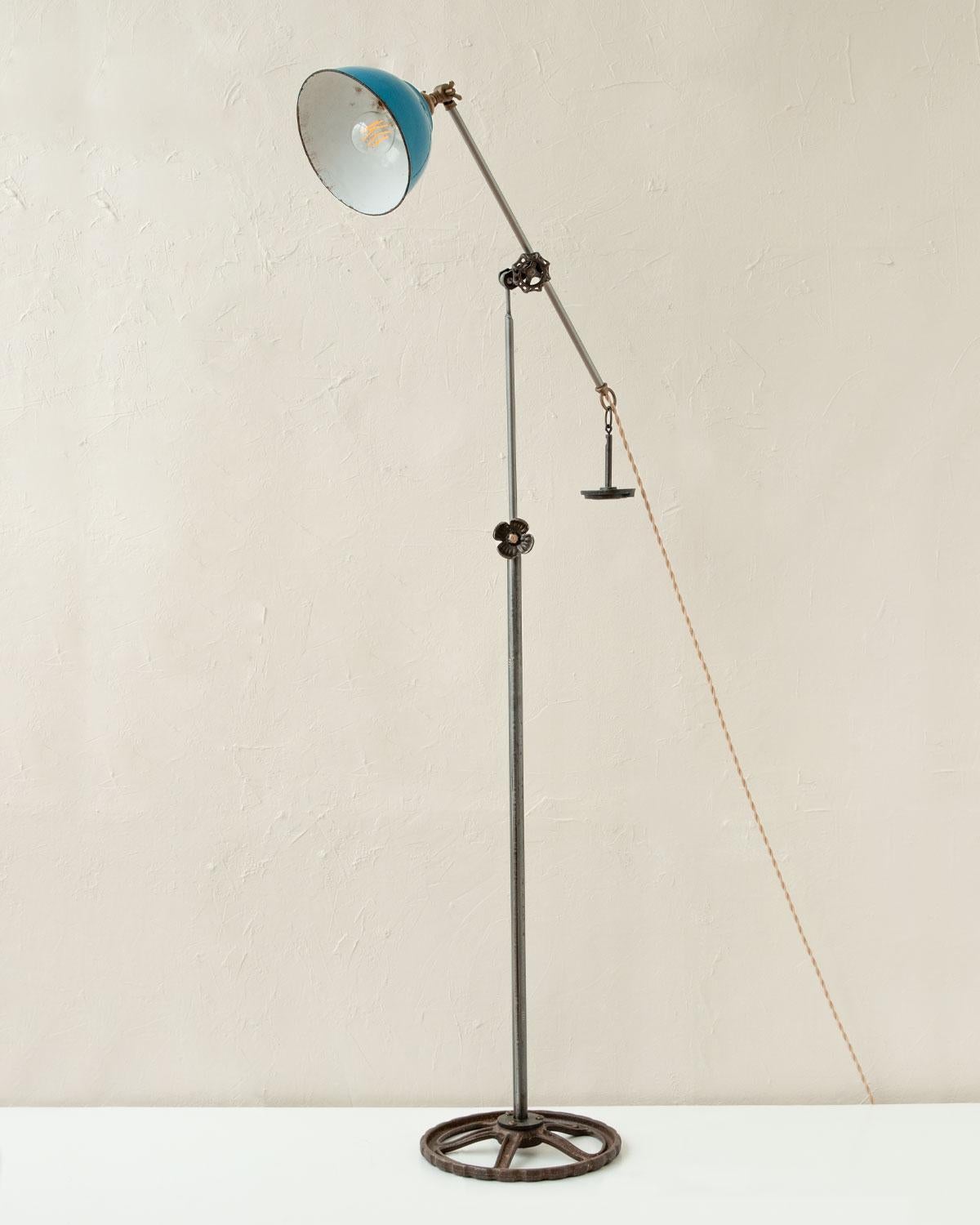 Robert True Ogden's one-of-a-like Found Object Lamps are made by hand in Philadelphia. Crafted from pieces and parts sourced locally and abroad, no two lamps are alike. 

This floor lamp has a vintage blue enamel shade, vintage gears that lock the